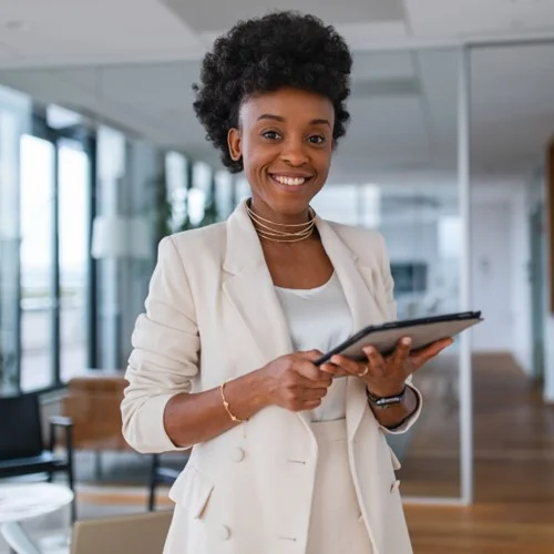 Client Portal image Business person stood in an office holding a tablet