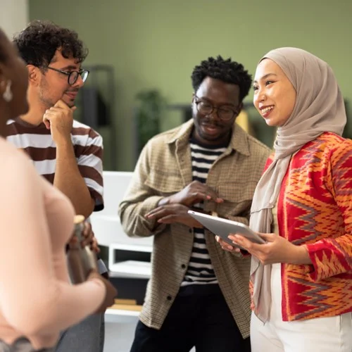 Talent Retention image Four business people stood in an office talking