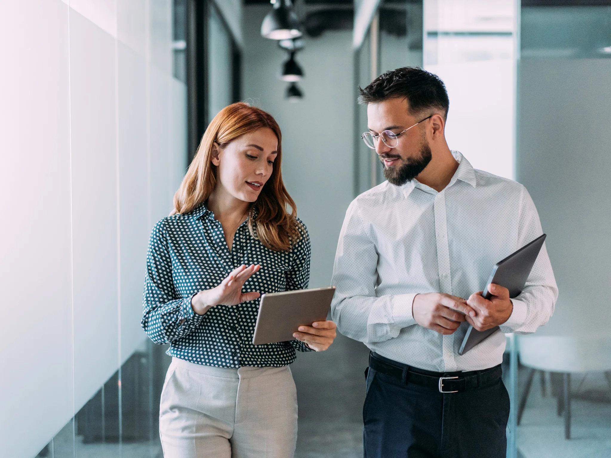 Two Account Managers reviewing a tablet