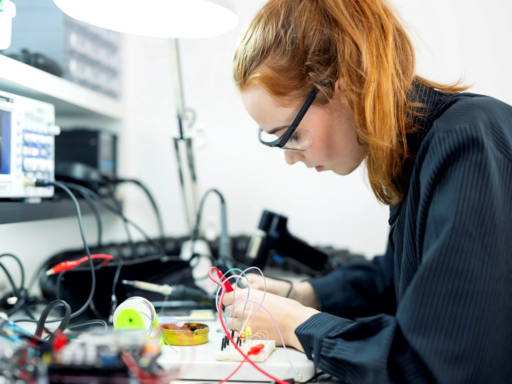 Electrical Engineer wearing safety goggles handling wires