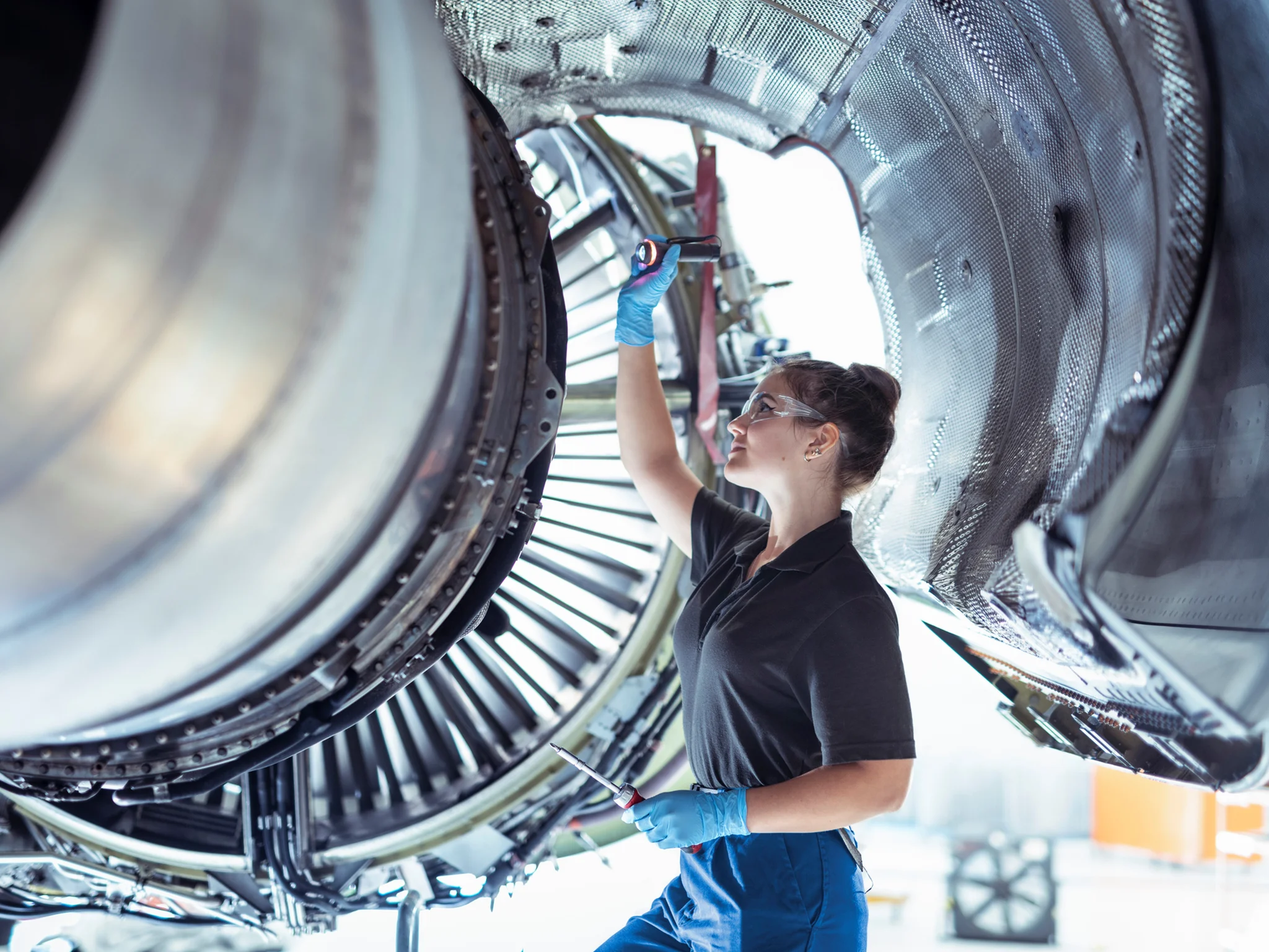 Aerospace technician inspecting a large jet engine