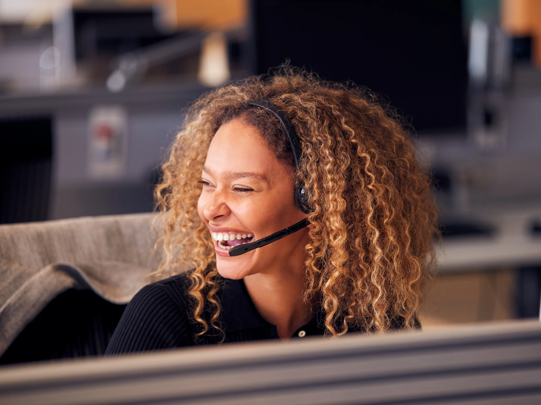 A happy Customer Service Advisor wearing a headset