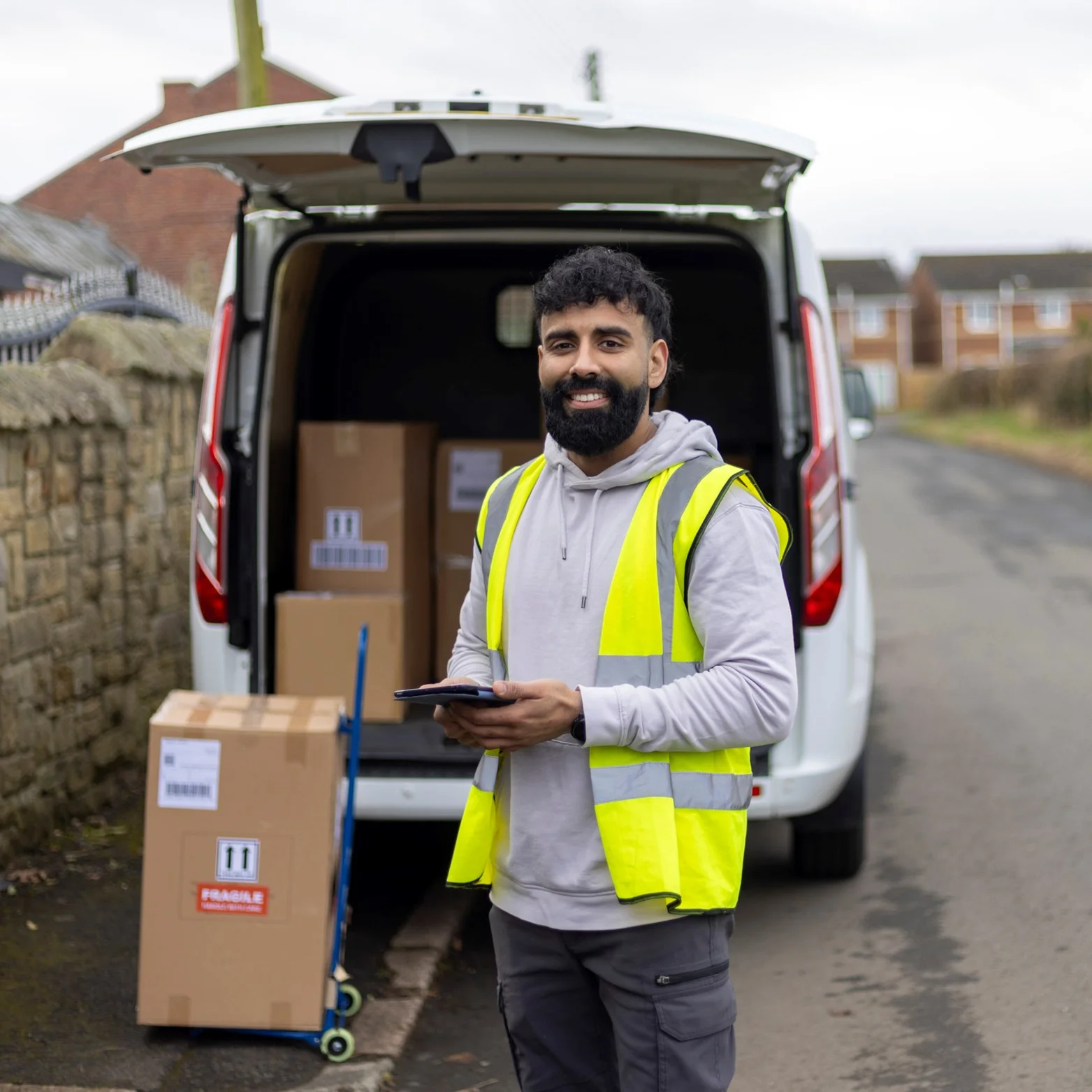 A smiling Delivery Driver outside making a delivery