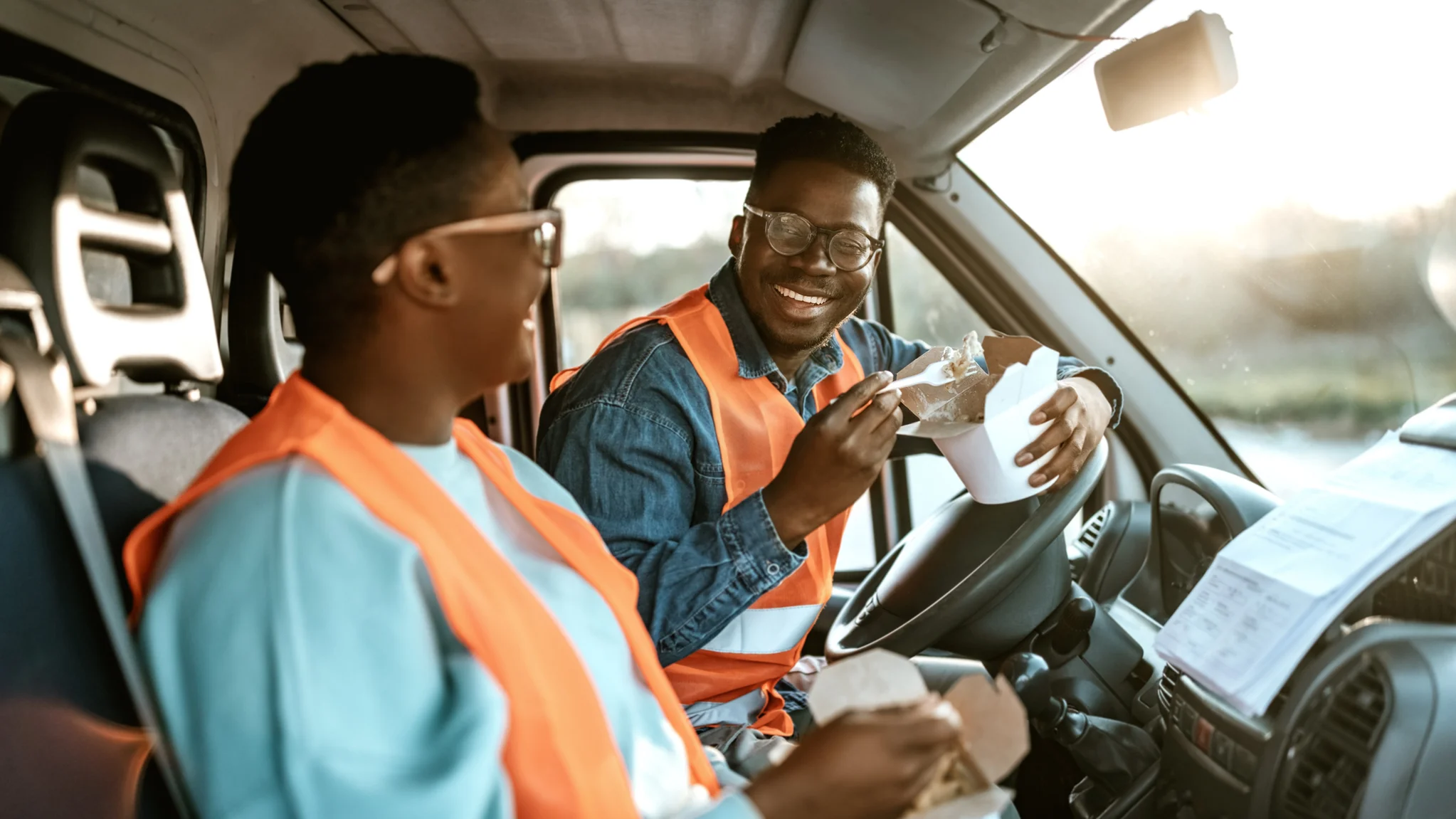 A smiling Drivers mate on their lunch break with a colleague