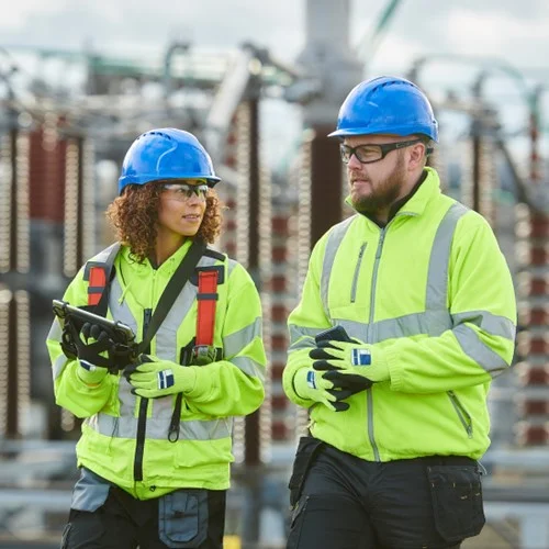 Energy & Utilities image Two Engineers in hi vis jackets and hard hats at an energy site