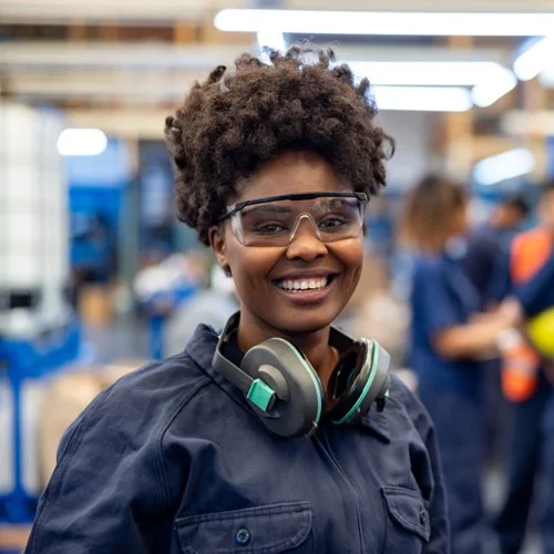 Engineering & Construction image A Manufacturing Engineer wearing protective googles and ear defenders around their neck
