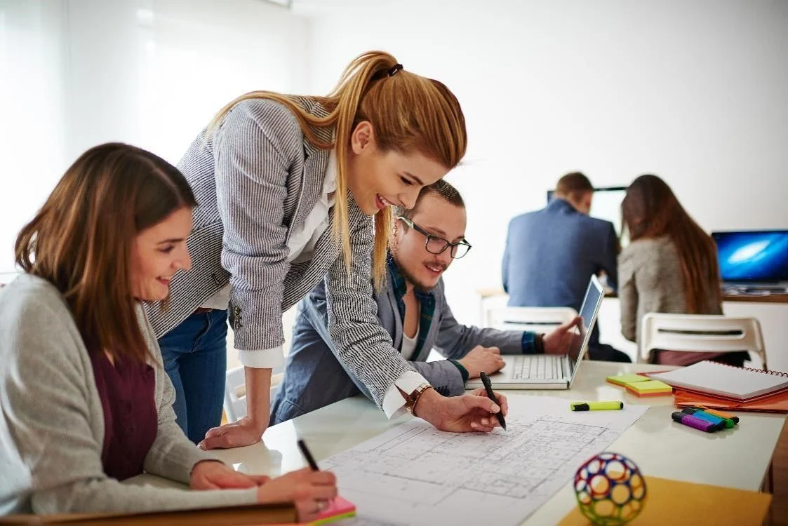 Three Event Coordinators in an office working together