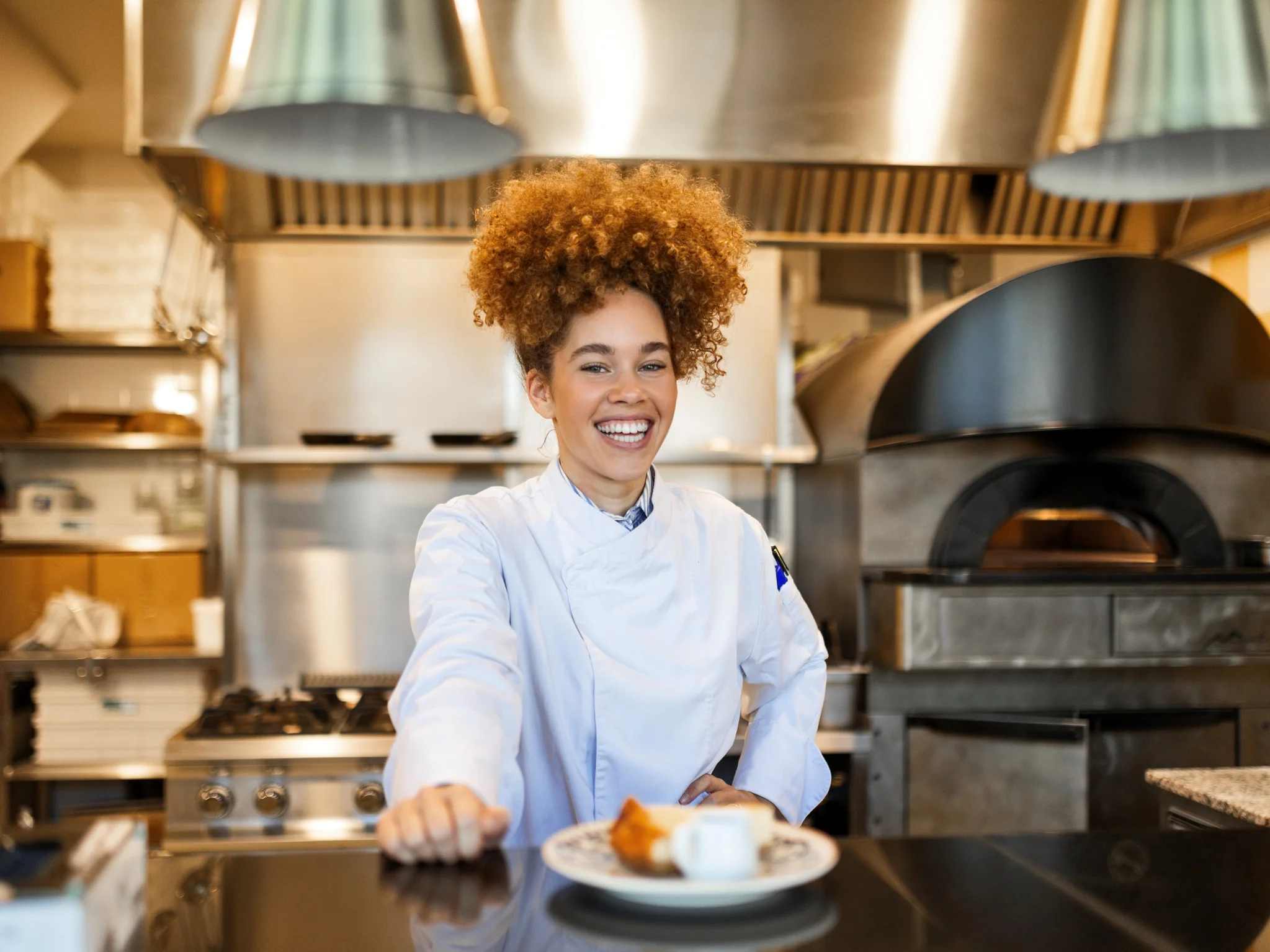 Smiling chef leaning on counter