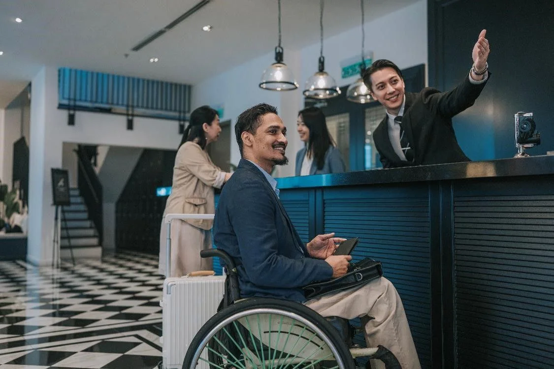 Hotel Receptionist speaking to a customer at the front desk