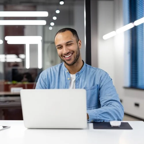 Information Technology & Technology image An IT Support Technician sat working at a laptop in an office