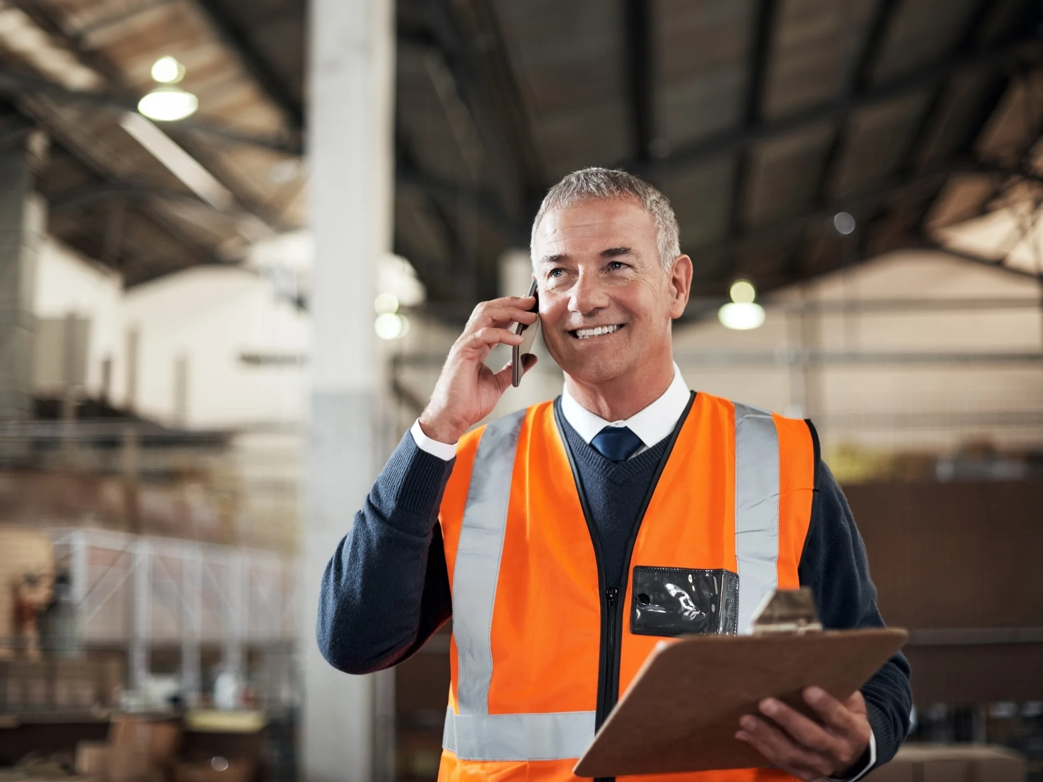 Smiling Logistics manager on the phone