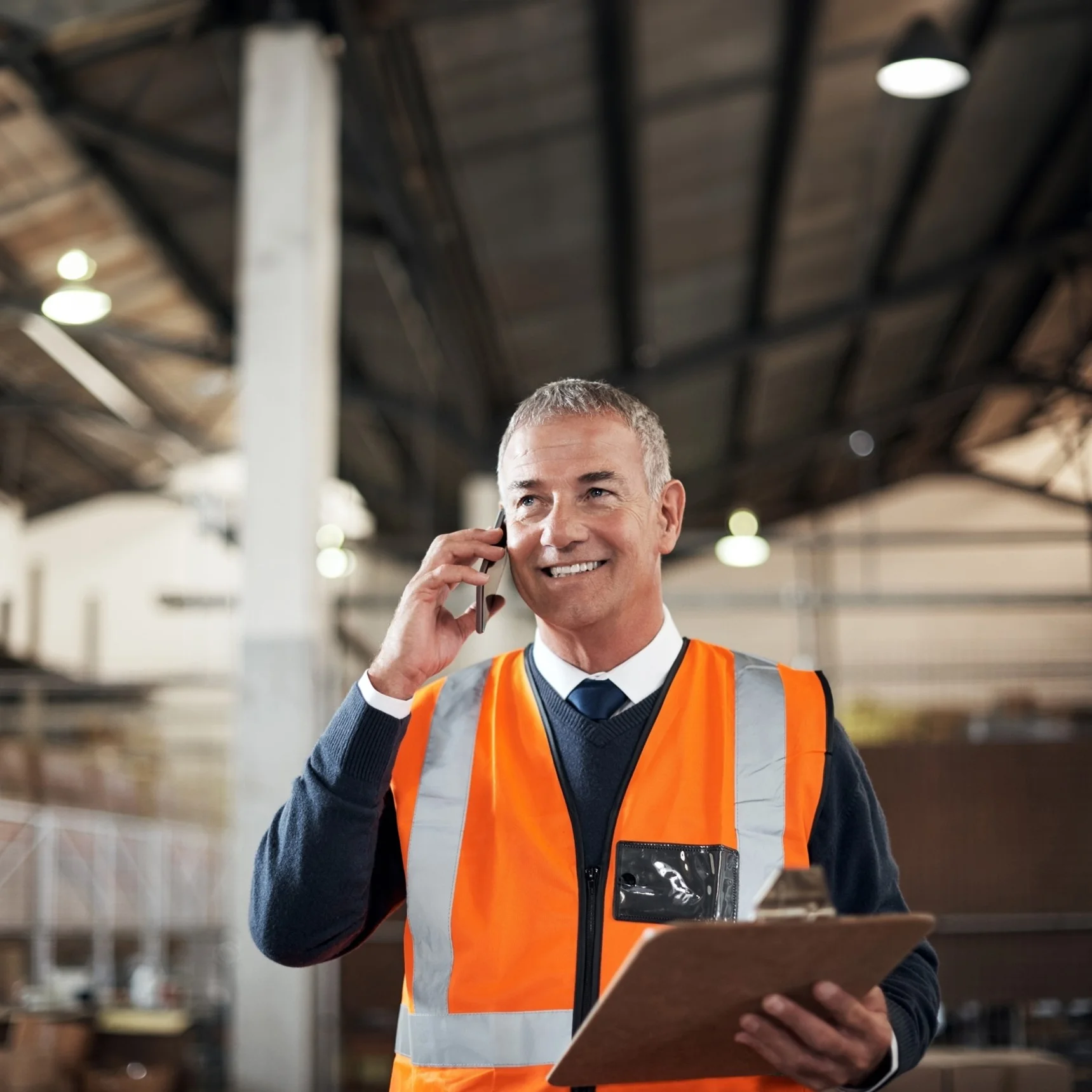Logistics worker on the phone in a warehouse
