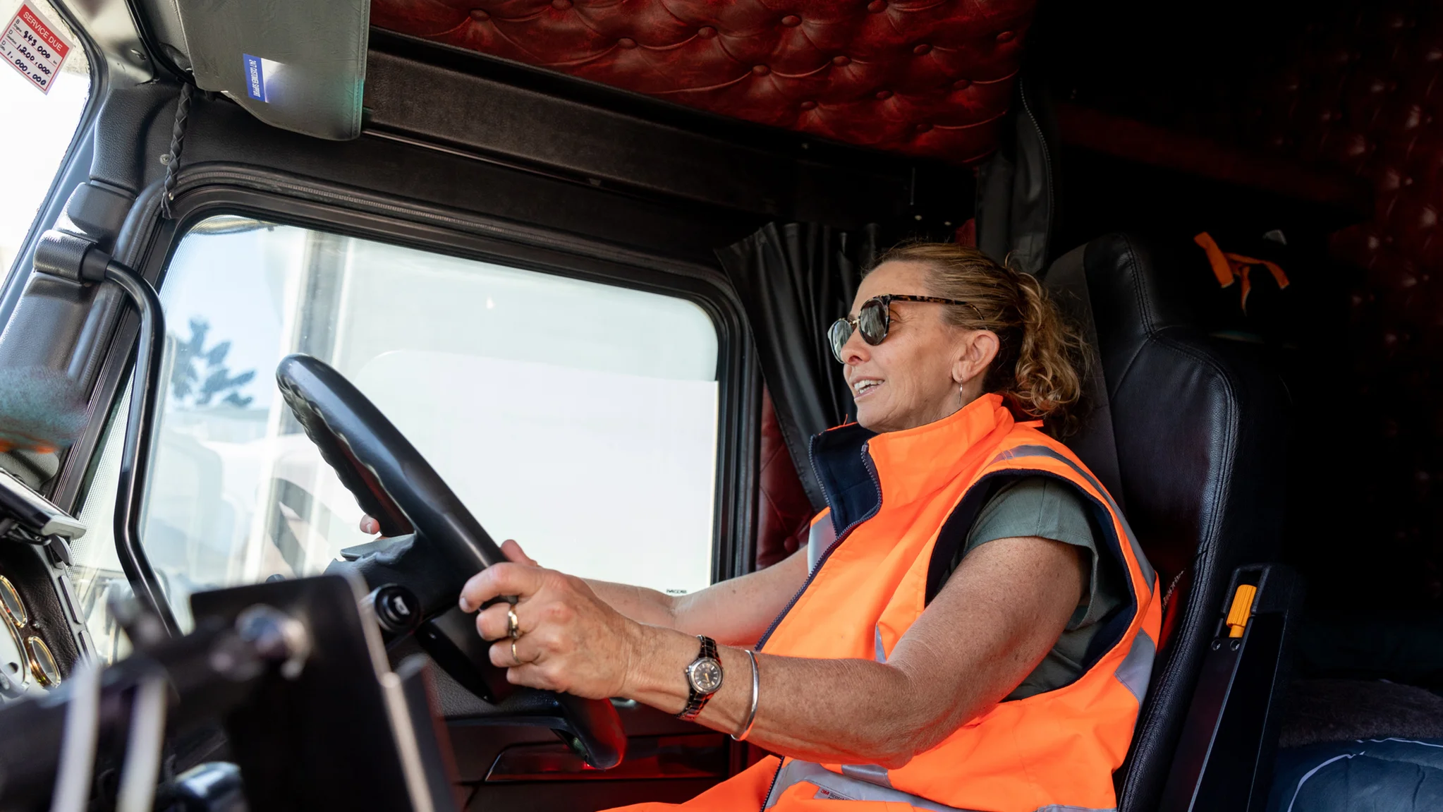 A HGV Driver driving a delivery lorry