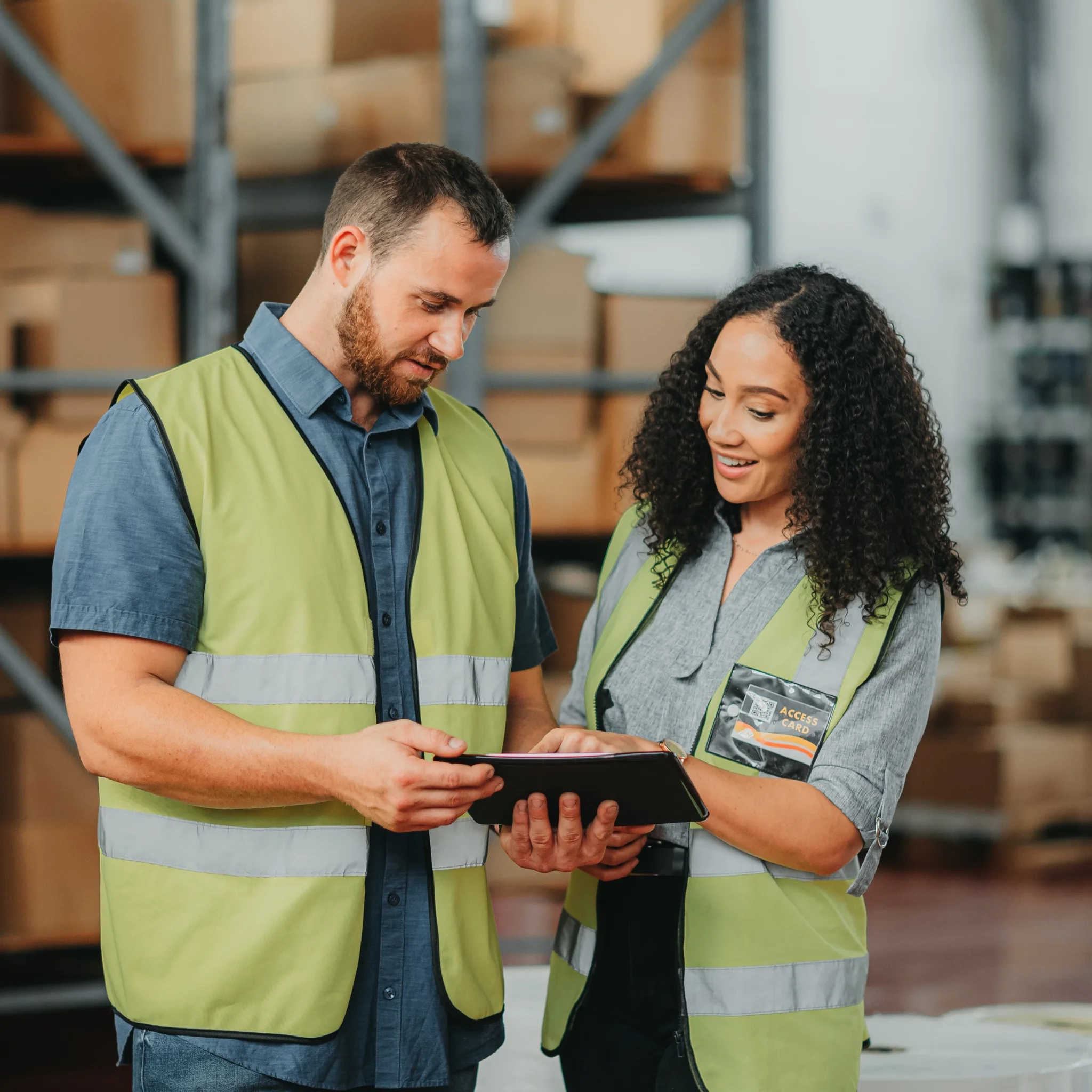 Two warehouse workers in discussion