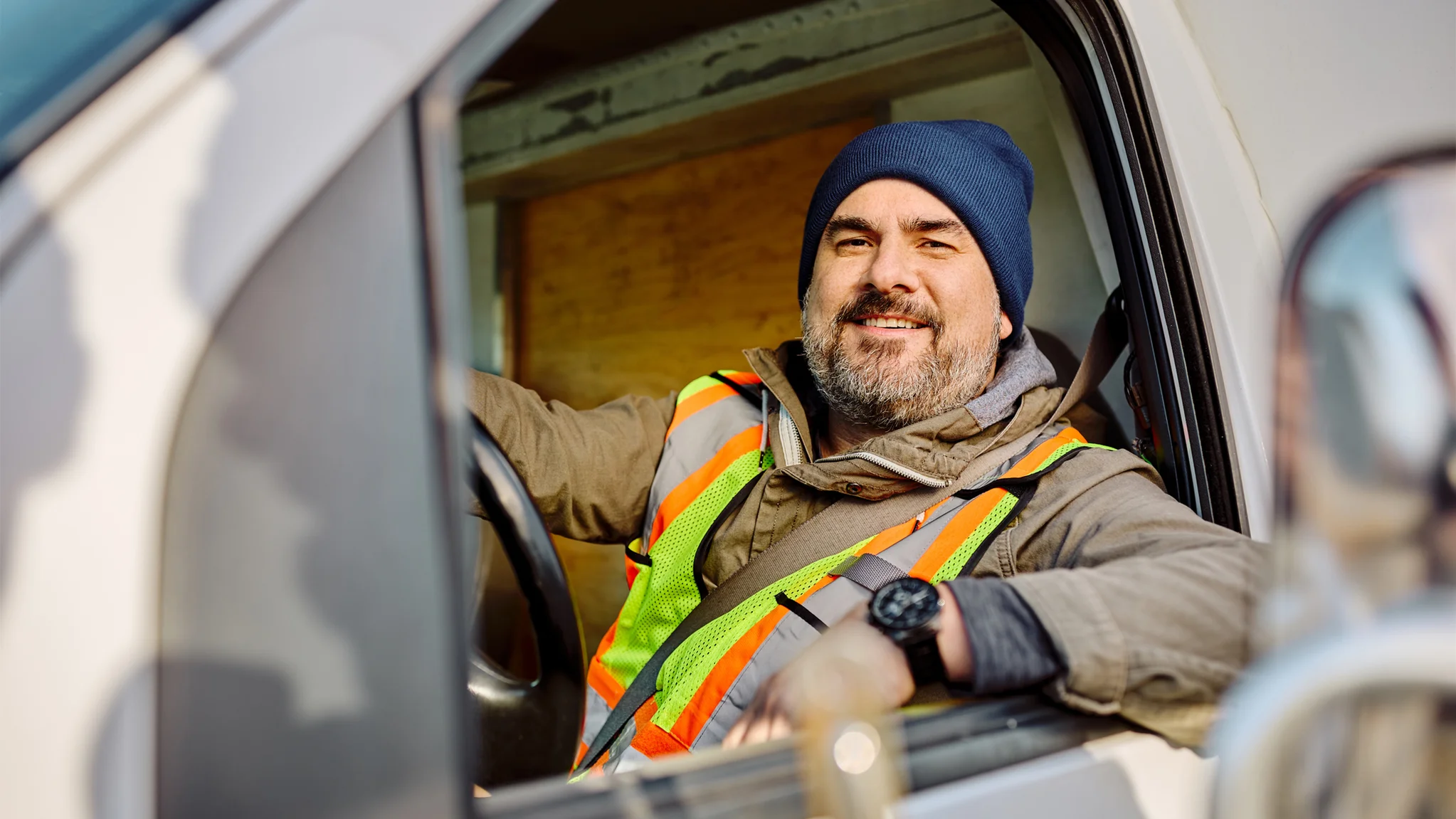 Smiling delivery driver in a vehicle