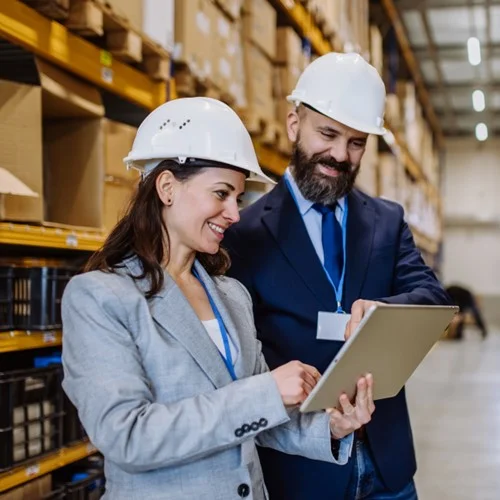 Service Change image Two warehouse managers wearing white hard hats