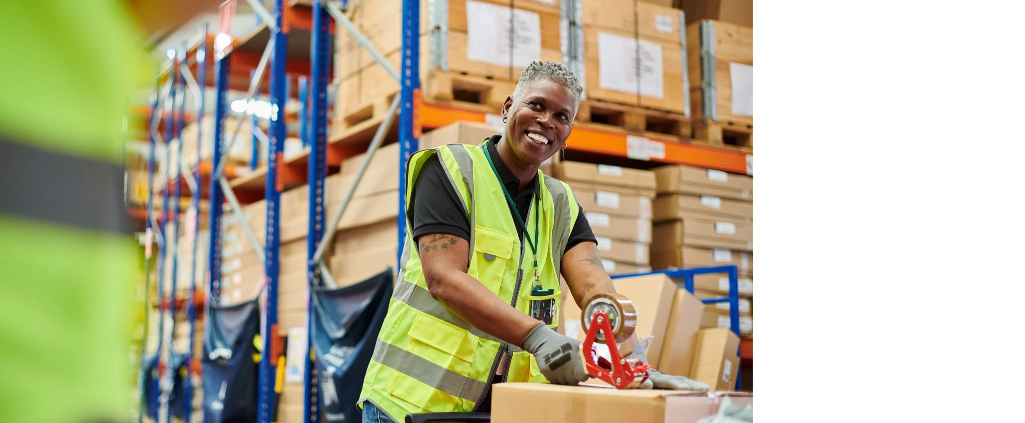Warehouse worker sealing a box with tape,