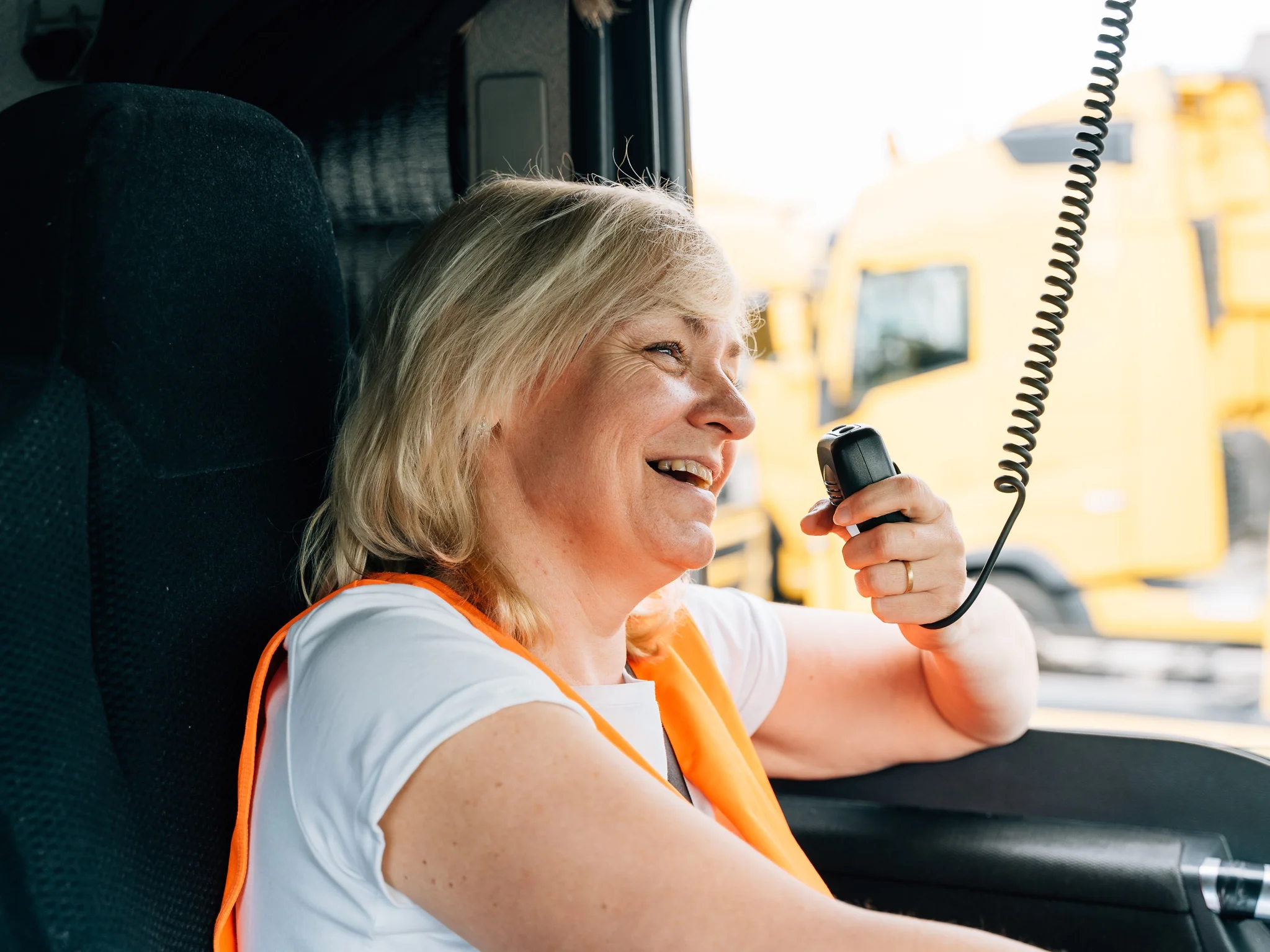 Smiling HGV Driver speaking into a radio