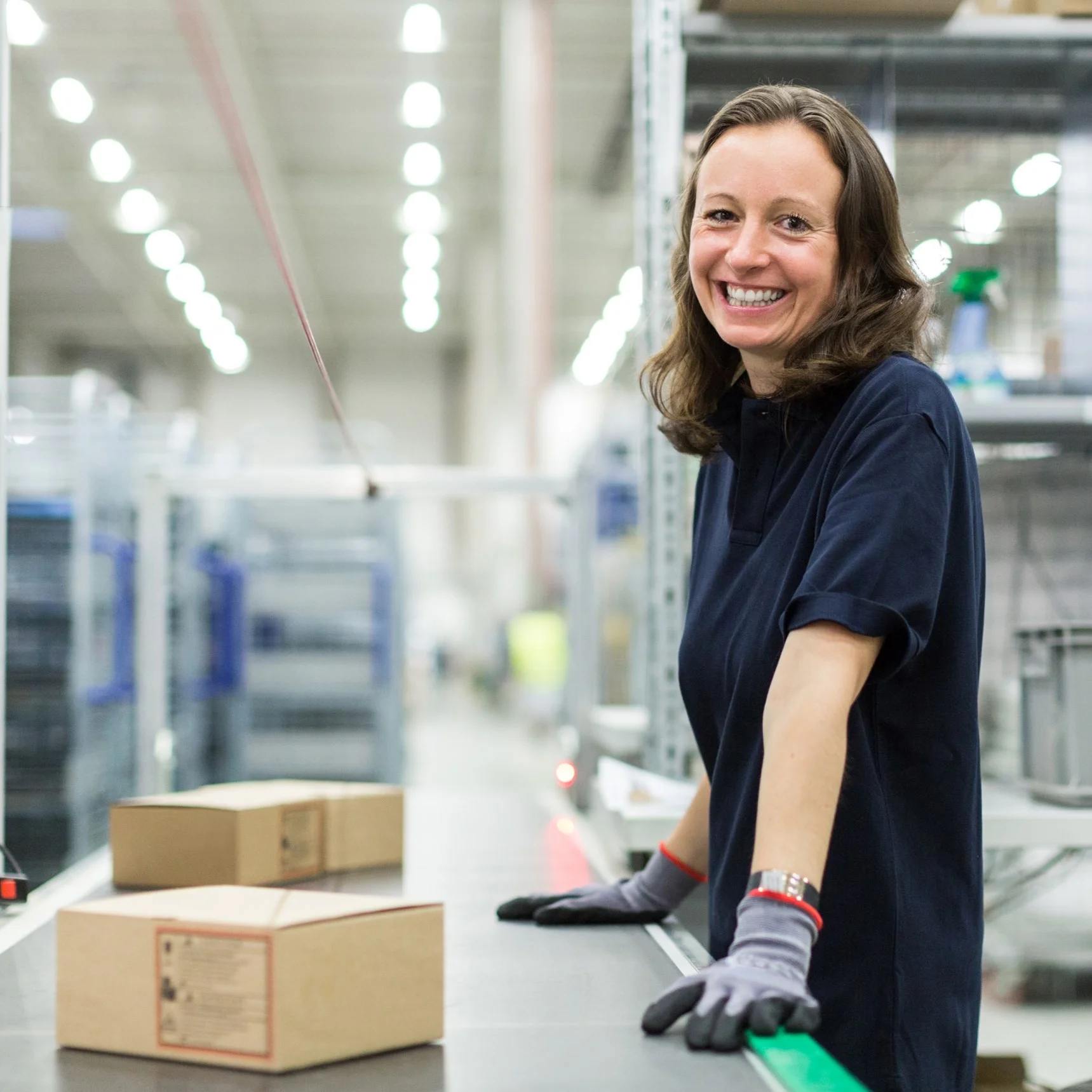 IKEA image Smiling warehouse worker wearing protective gloves while preparing orders in a warehouse