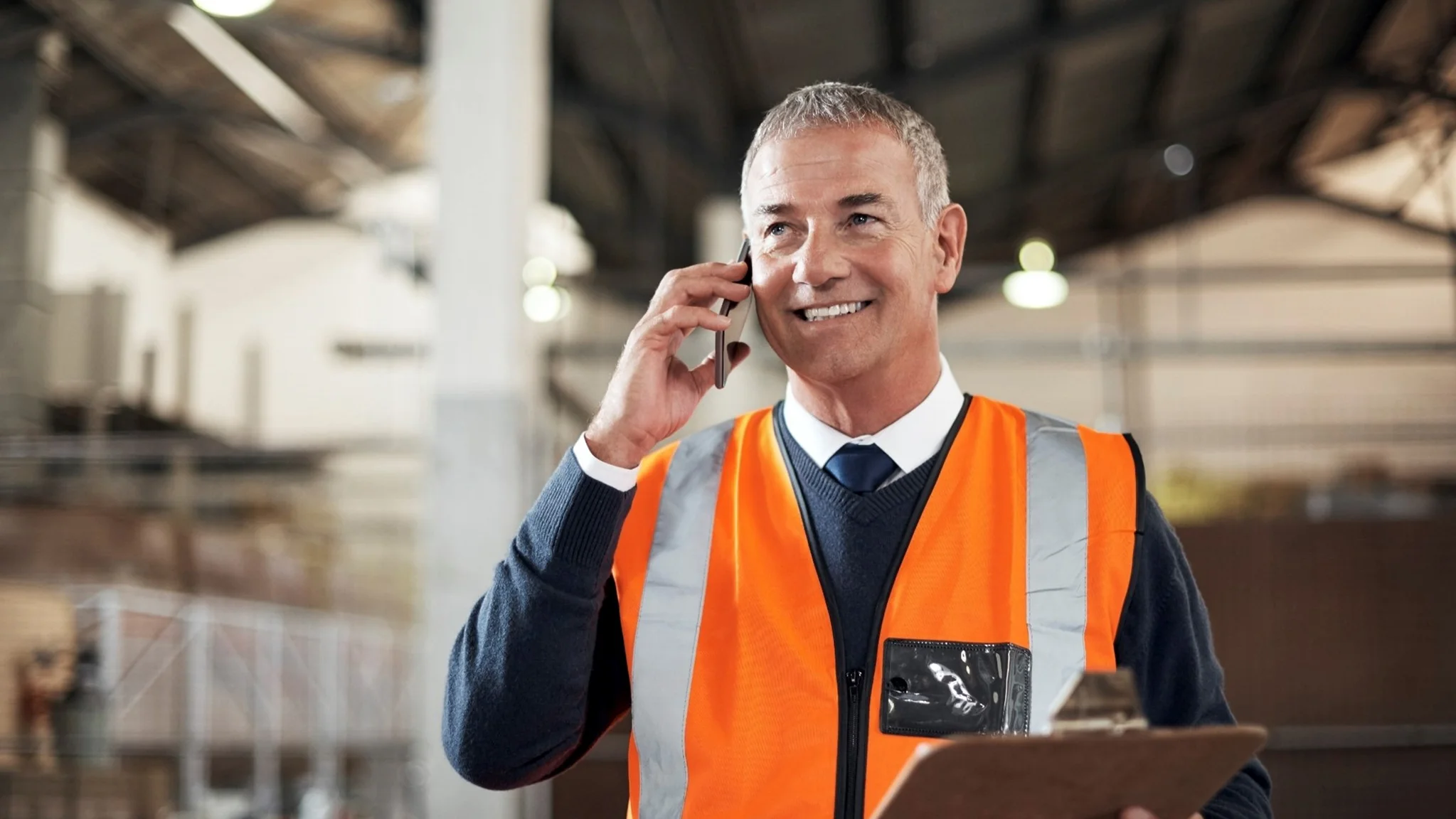 Transport Manager talking on the phone and holding a clipboard
