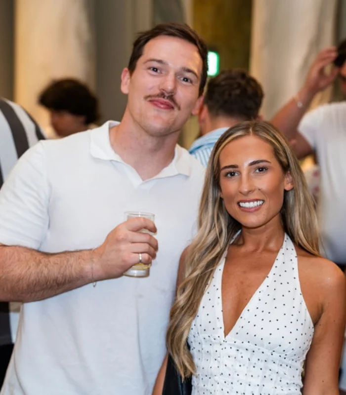 A brunette man and blonde woman at recruitment award ceremony 
