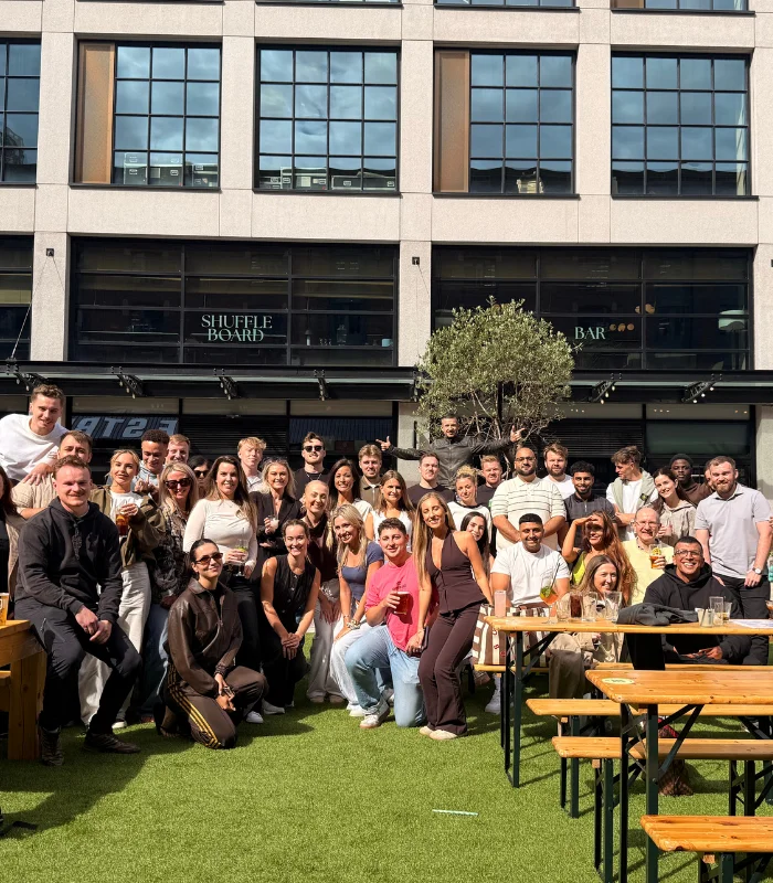 Large group of men and women posing for a photo during recruitment incentive