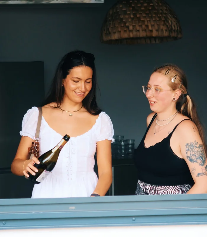 two women pouring drinks at staff party