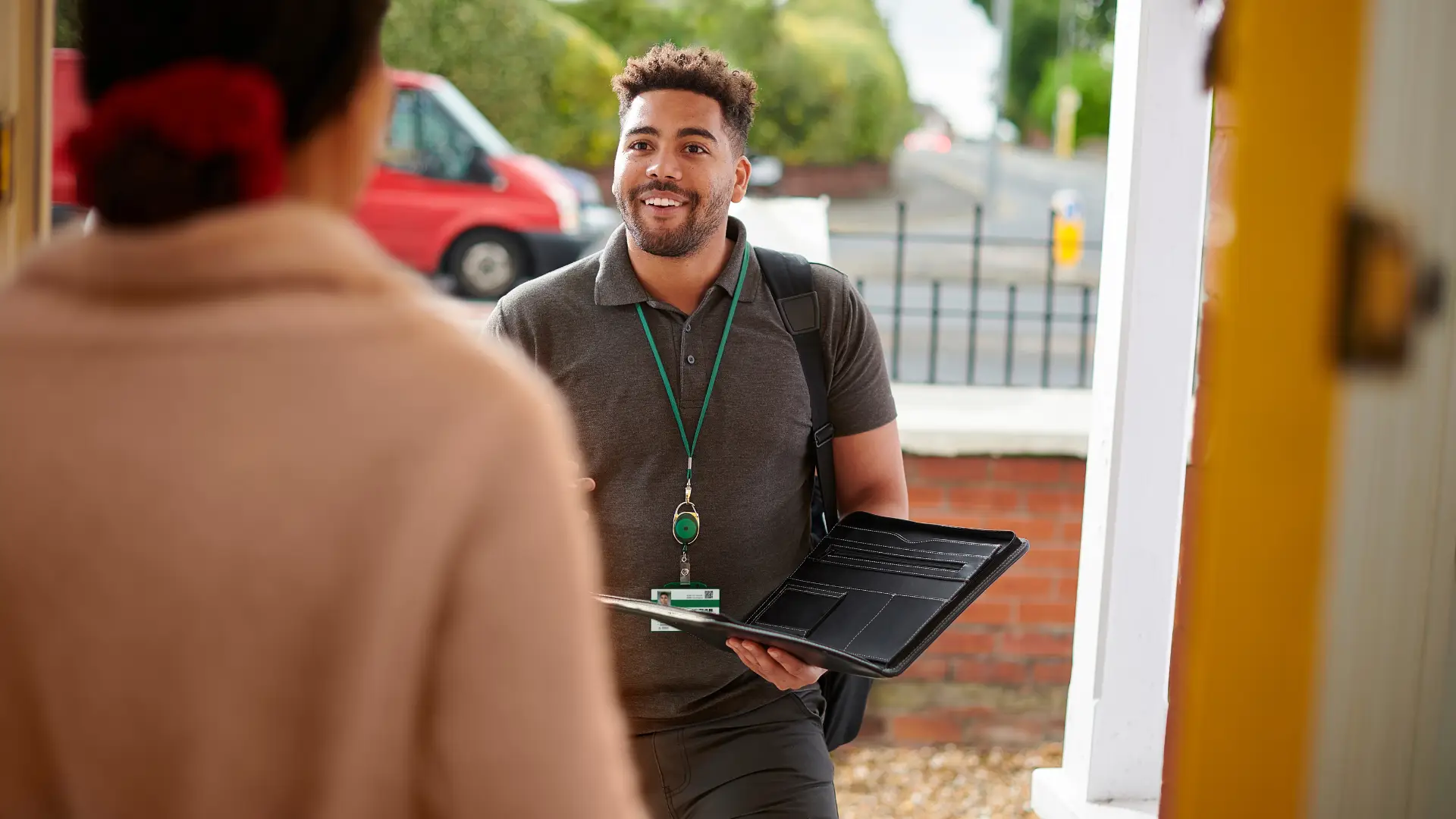 Social Housing worker at a door talking to a tenant
