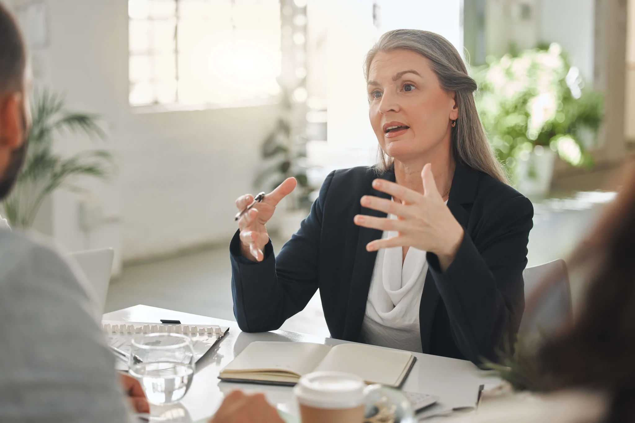 lady at desk conversing to people