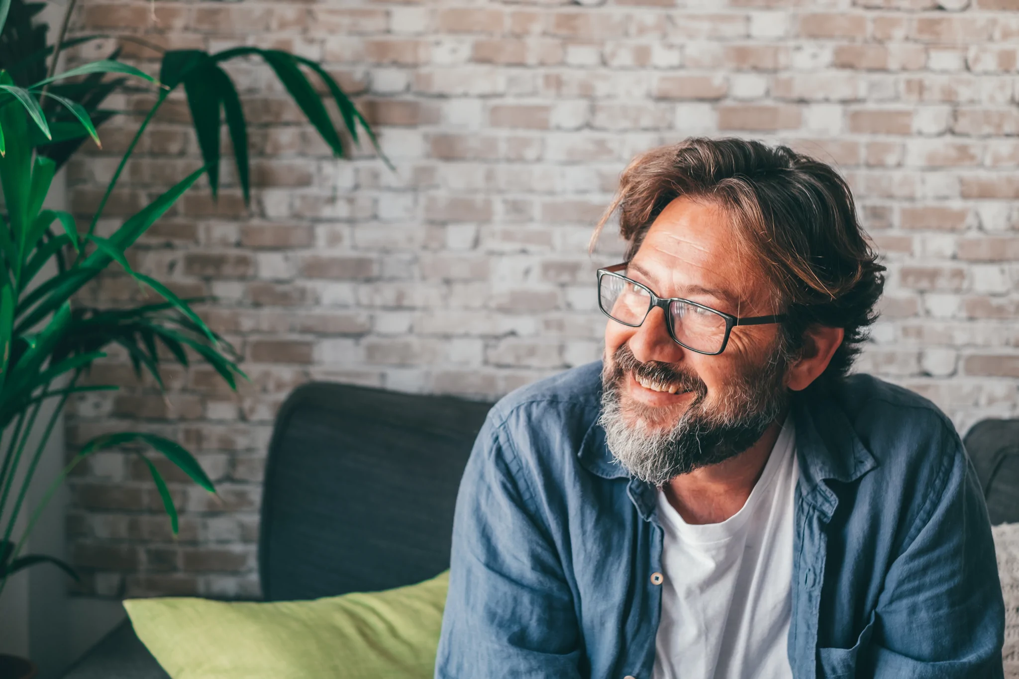 man sitting looking out smiling