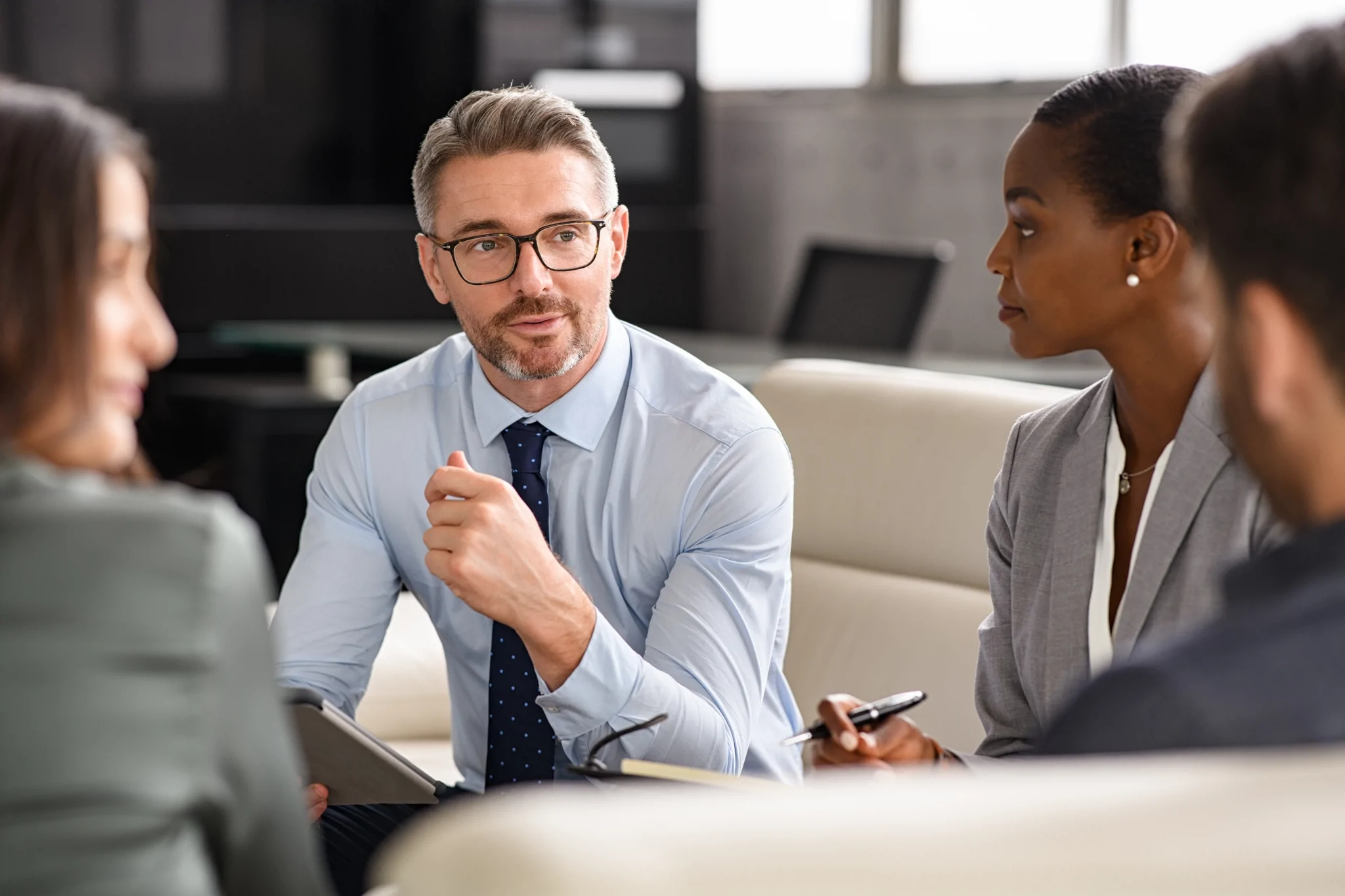 group of professionals sitting down conversing