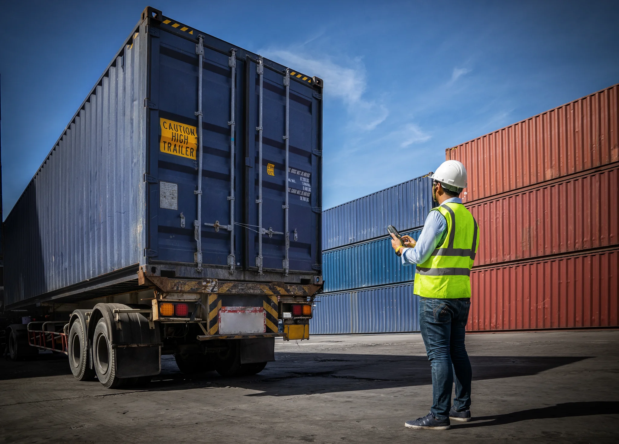 Foreman control loading Containers box to truck for Logistic Import Export Background, Business logistic concept, import and export concept