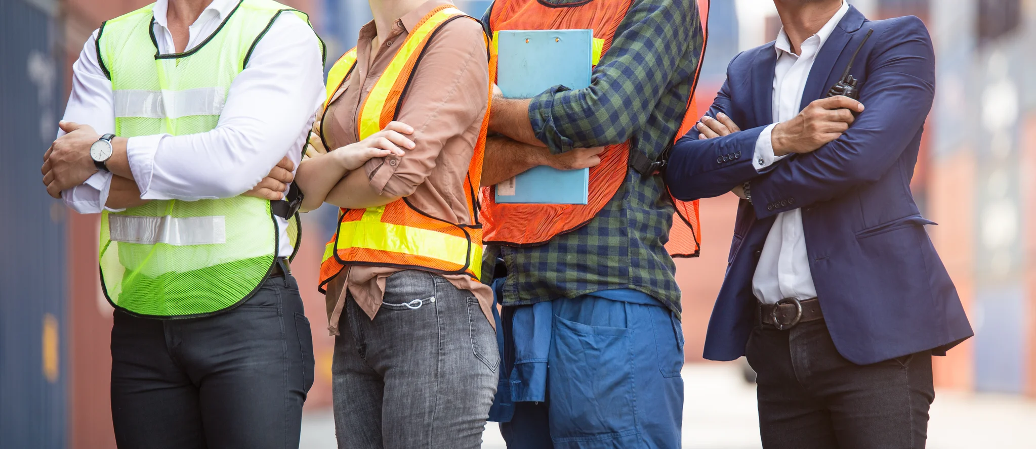 Banner of factory construction site or container warehouse people standing with arms crossed.