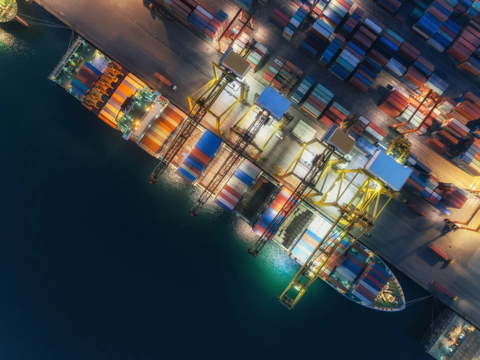 aerial-view-container-ship-at-sea-port-and-working-crane-bridge-loading-container-for-logistics-import-export-or-transportation-concept-background-