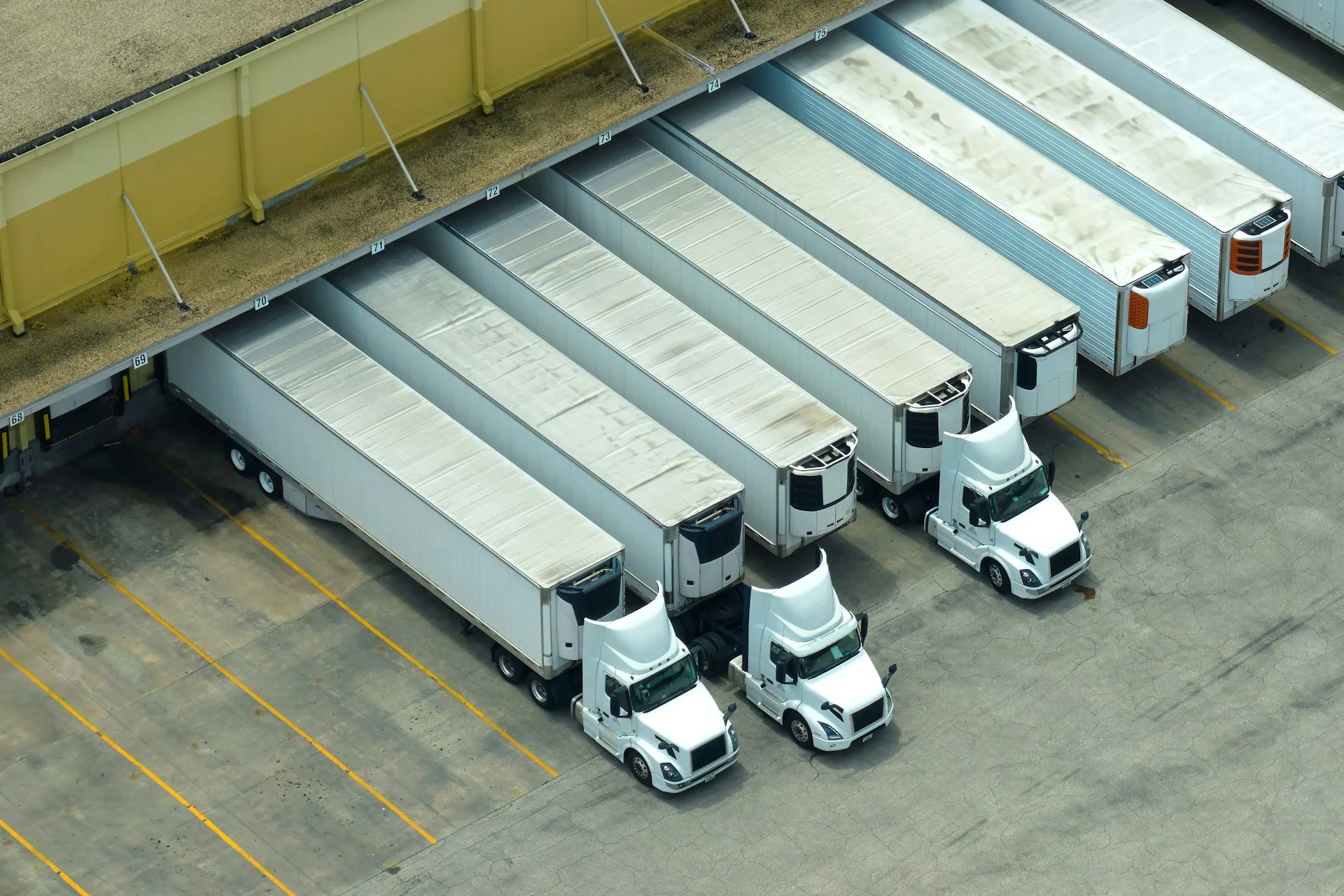 photos/big-corporate-shipment-center-with-many-cargo-semi-trucks-unloading-and-uploading-retail-products-for-further-retail-shipment-global-market-concept