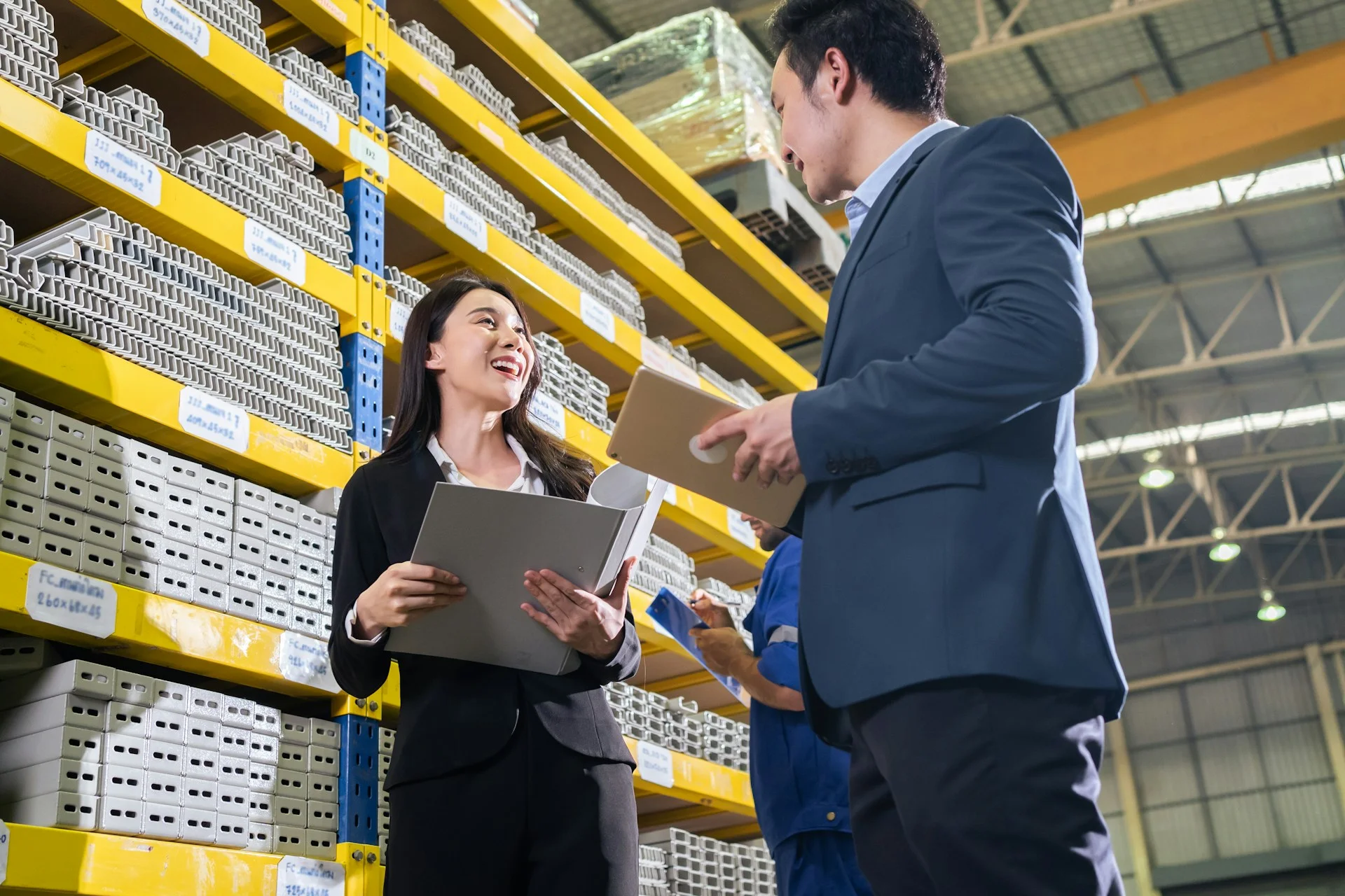 asian-business-woman-work-in-industry-manufacturing-plant-with-partner-attractive-industry-factory-engineer-people-in-formalwear-processes-orders-and-product-at-manufactory-warehouse-with-happiness-