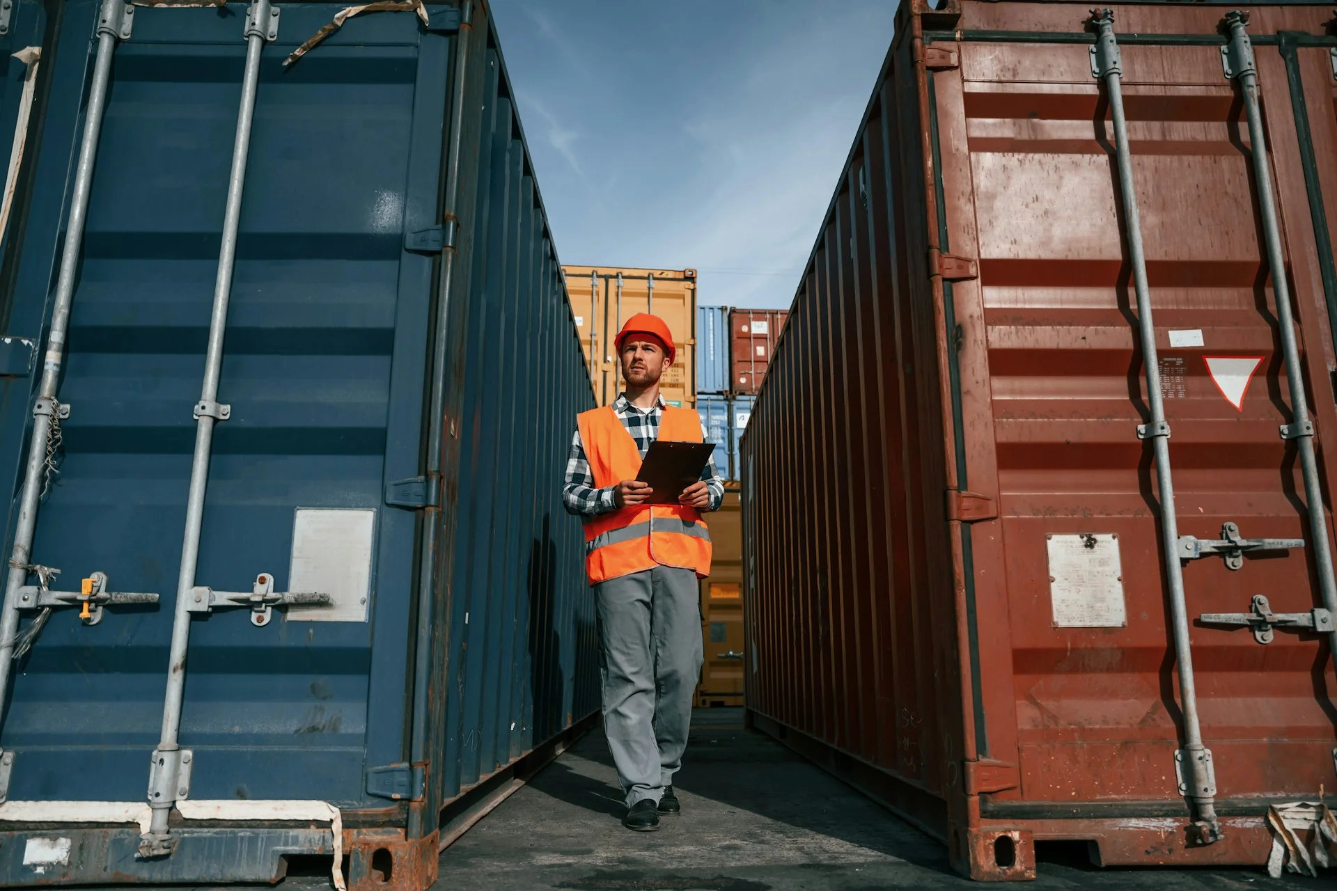 Man-walking-between-containers