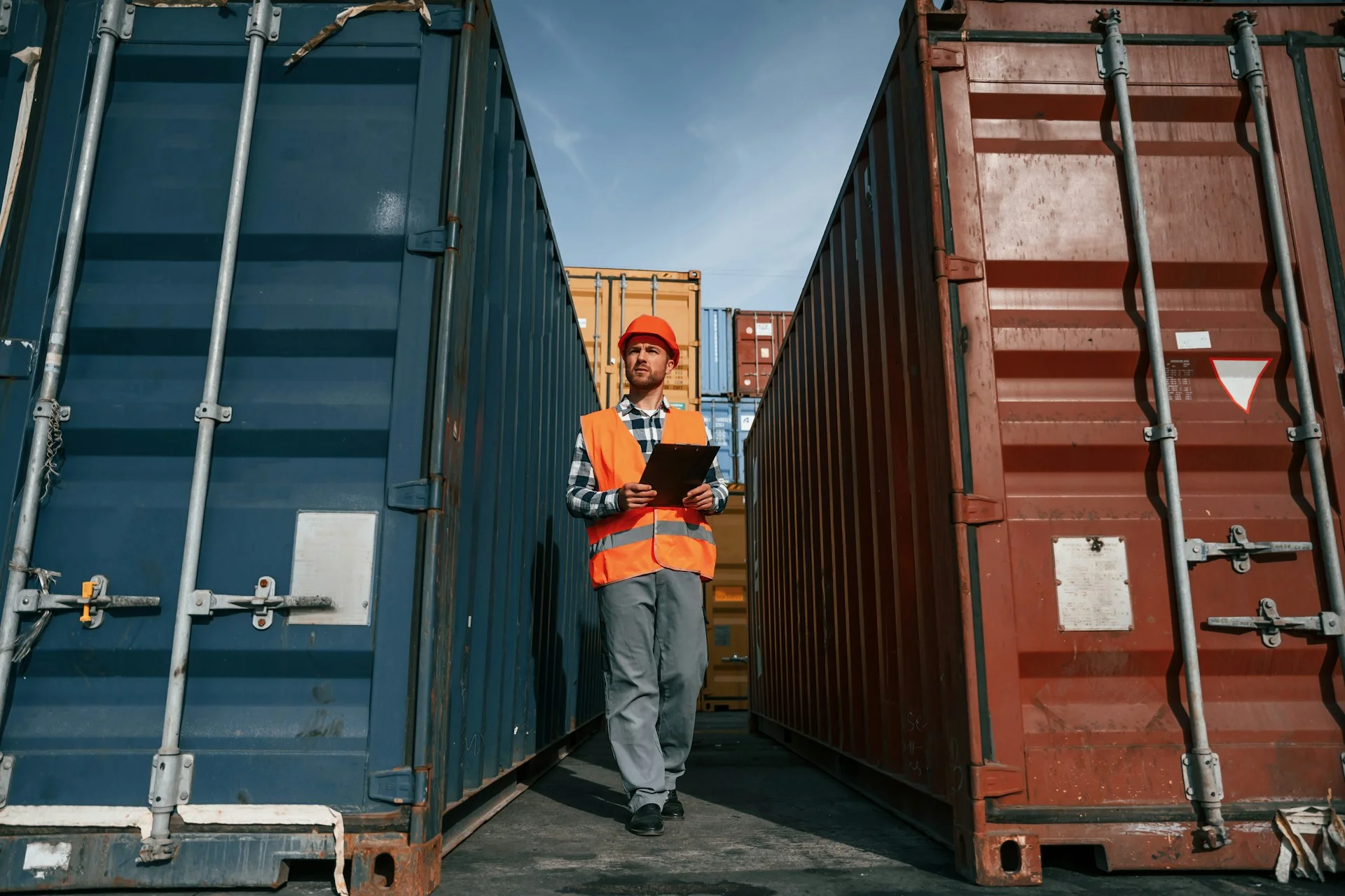 male-worker-is-on-the-location-with-containers-using-digital-tablet-