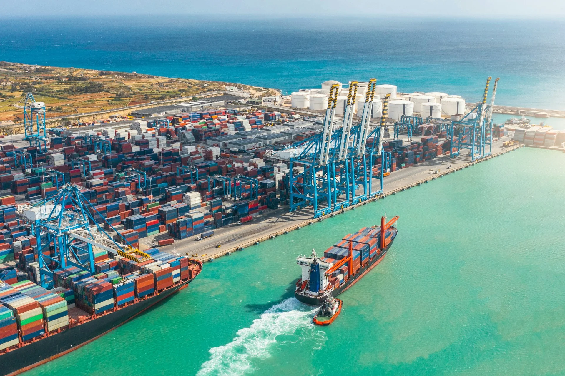aerial-view-of-a-huge-port-with-containers-and-cargo-ships-entering-the-port-for-loading-and-unloading-