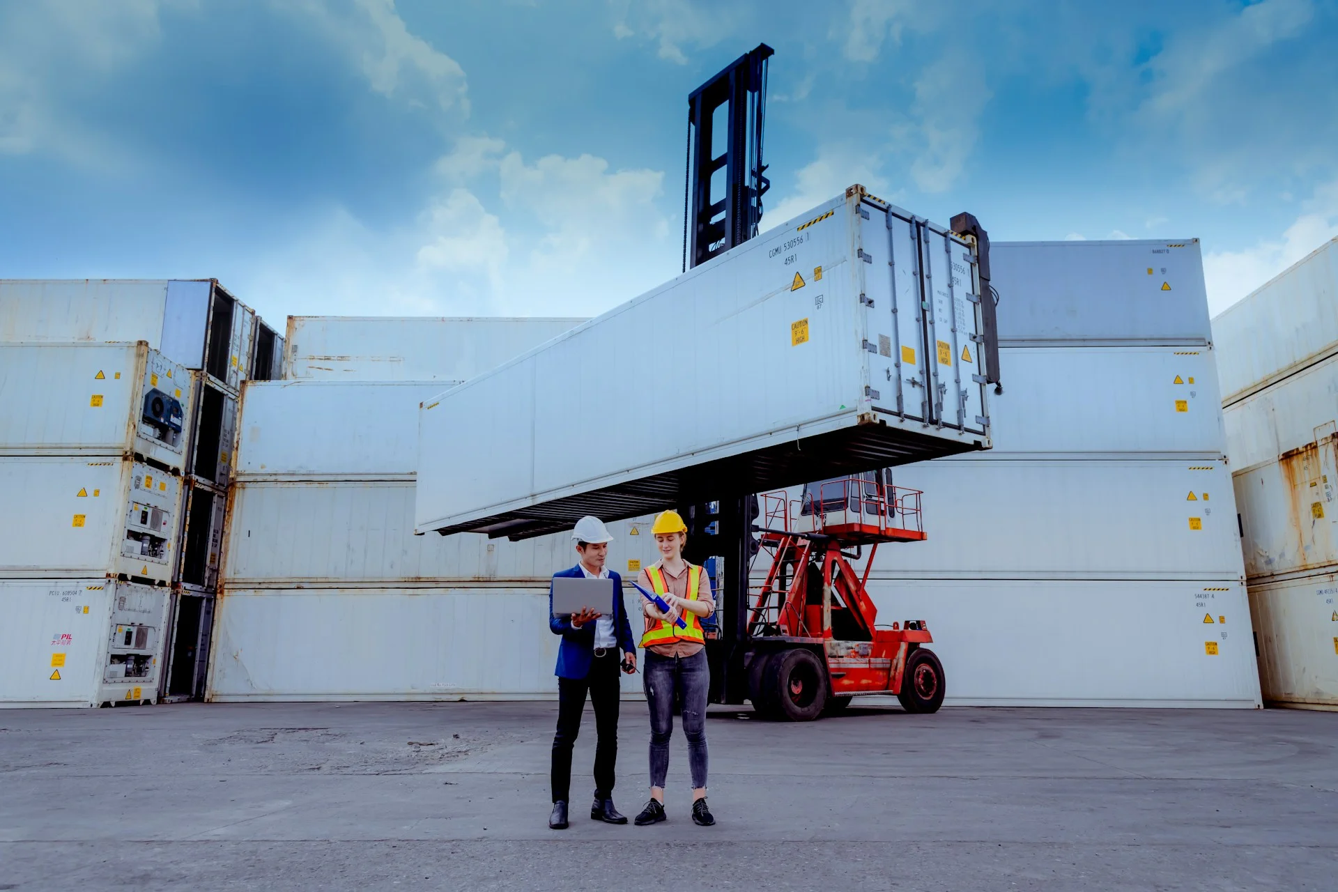 manager-and-dock-worker-under-discussion-about-dock-container-shipping-warehouse-documentthey-wearing-safety-uniform-hard-hat-and-hold-radio-communication-