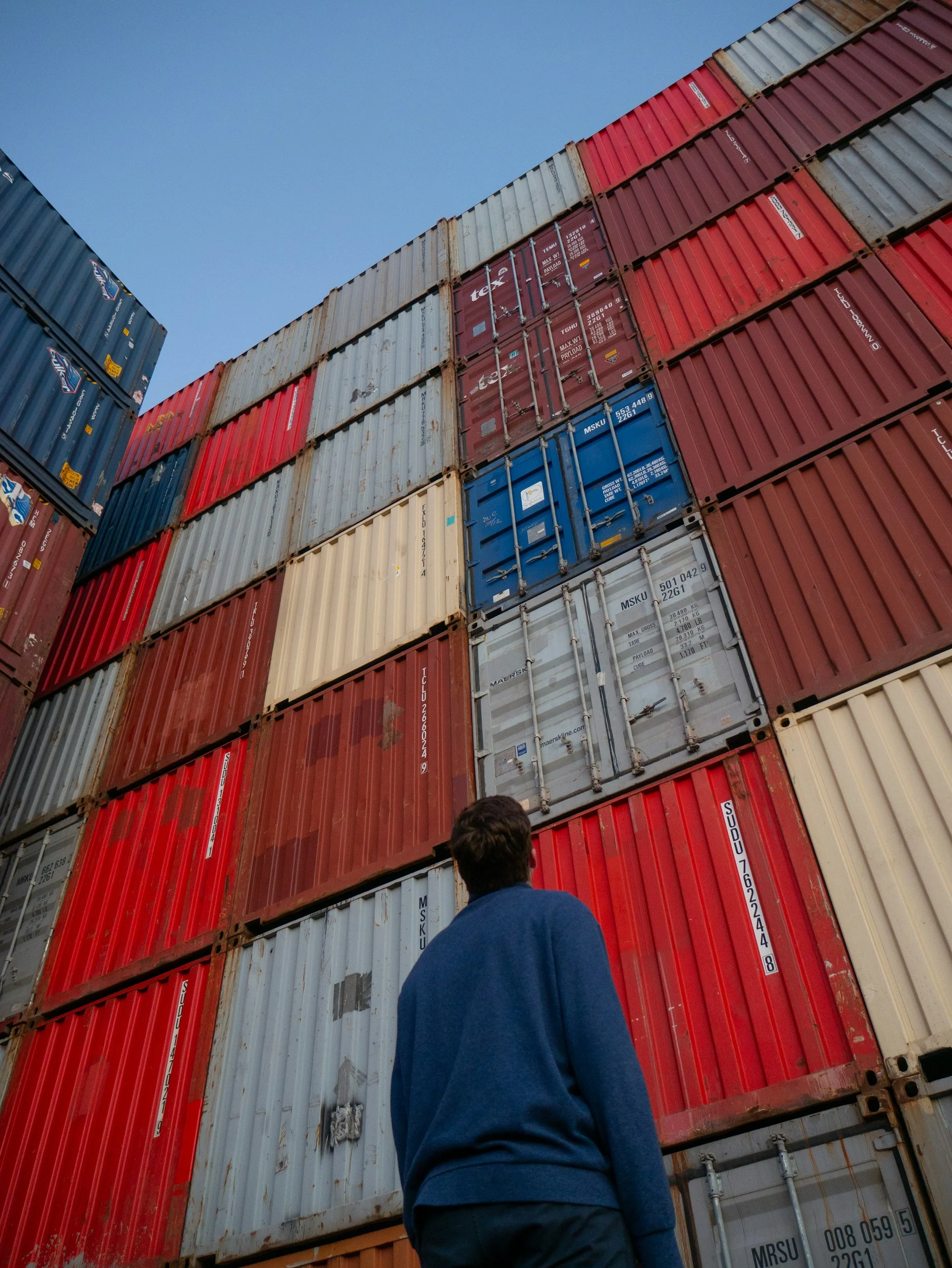 Man Looking up and containers