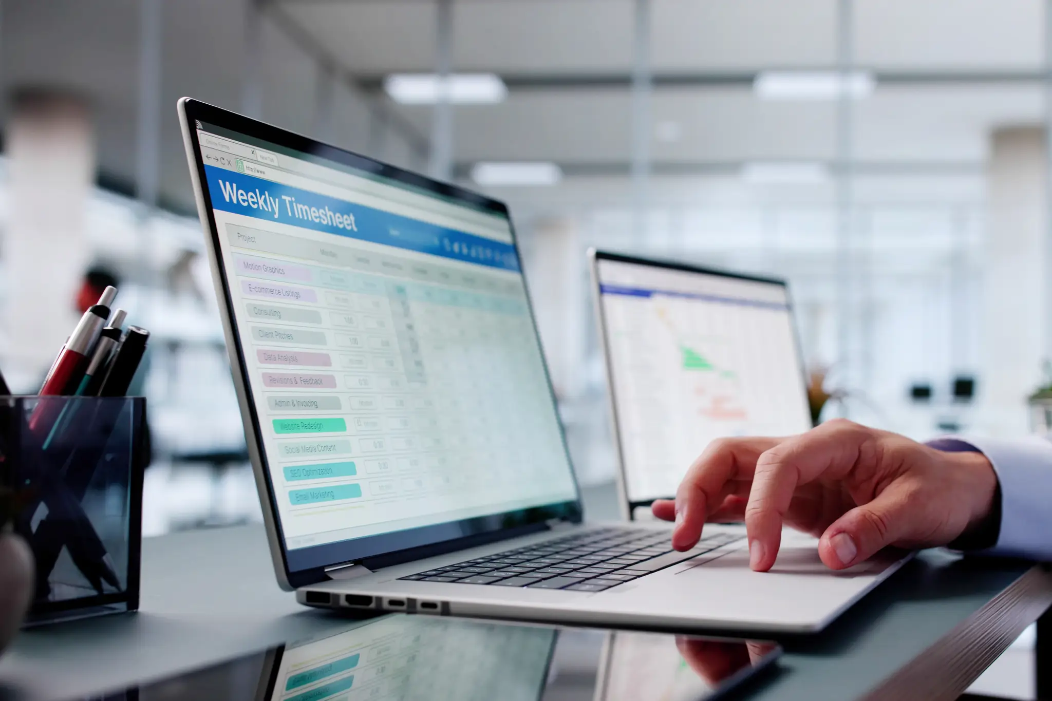 Man filling in timesheet on computer