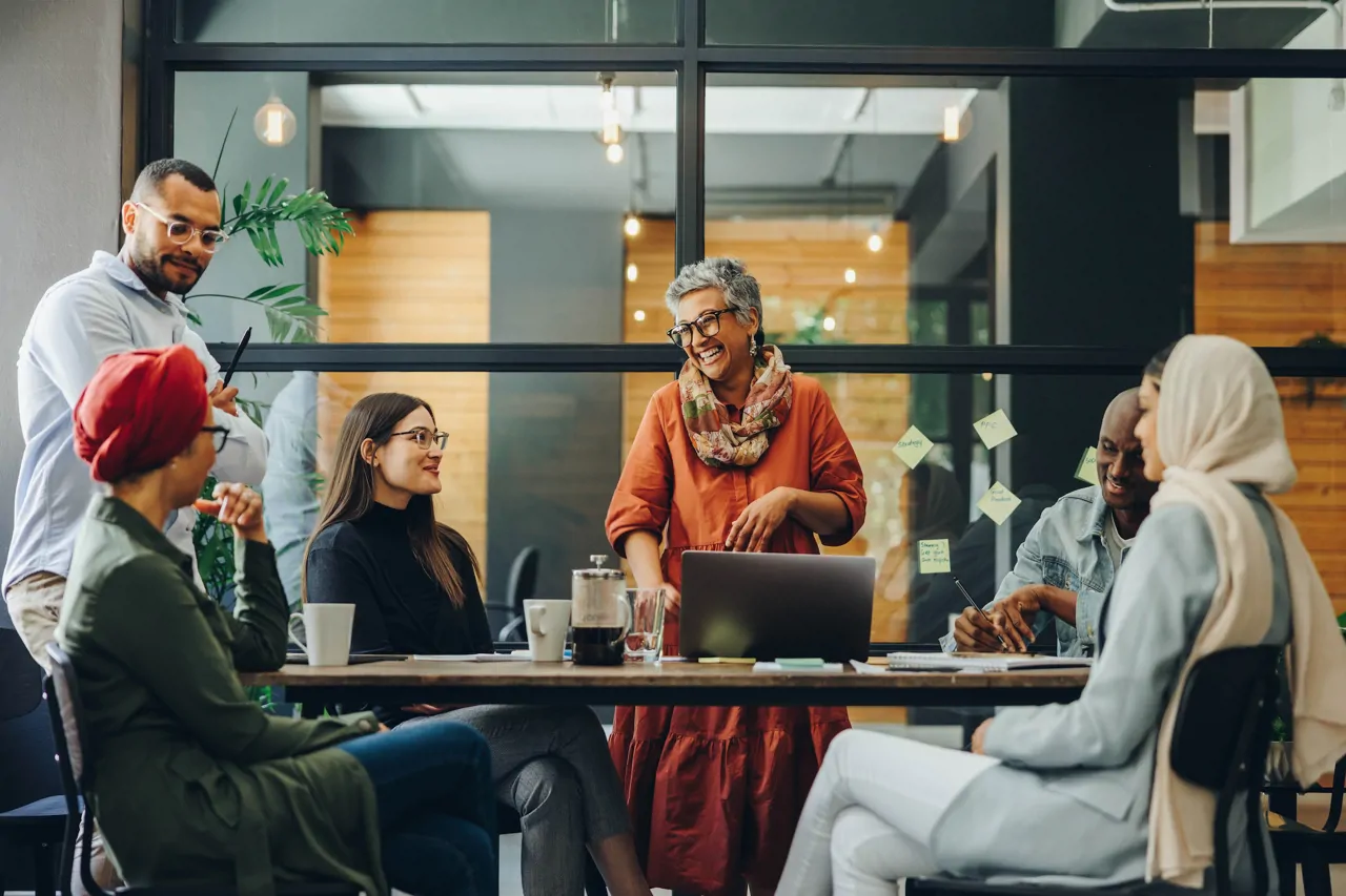 Colleagues laughing in a work meeting