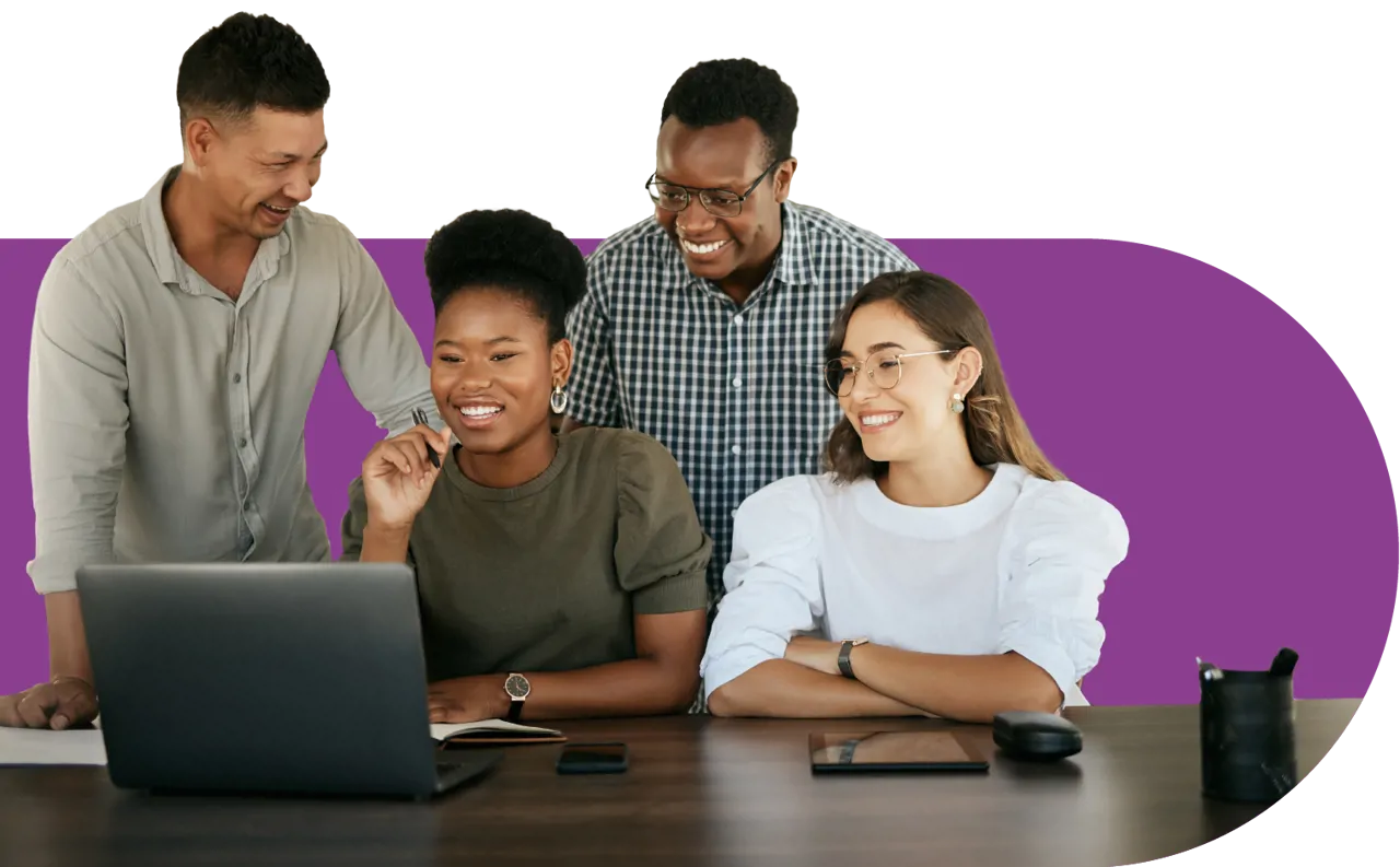 4 people sat and standing at a desk around a computer on a purple background