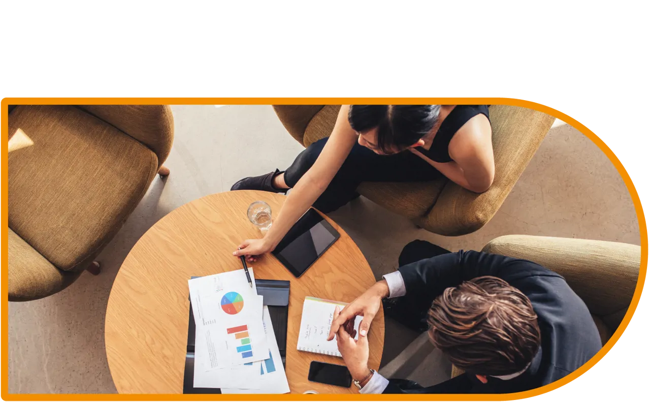 Aerial shot of two people having a business meeting at a table.