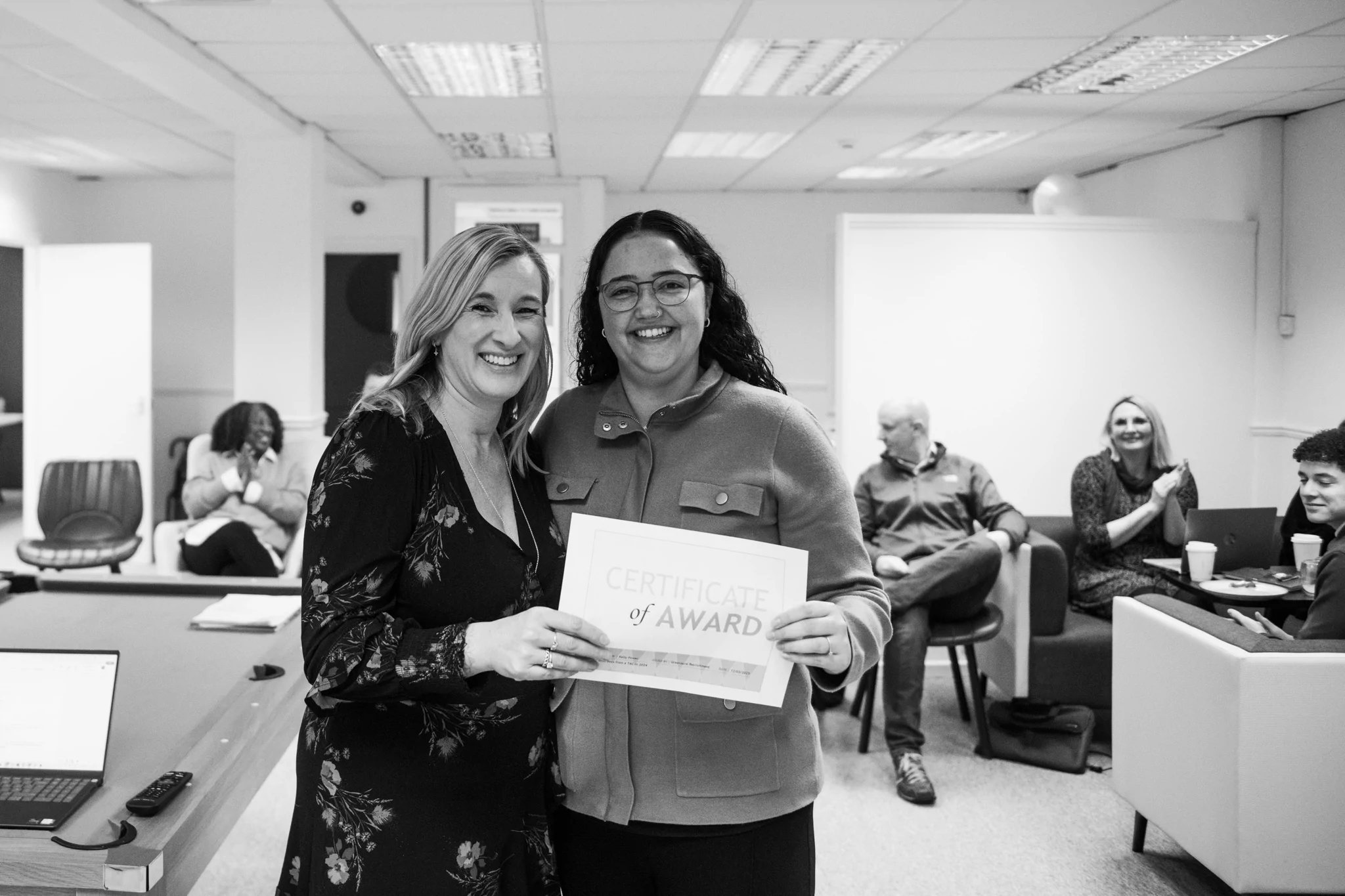 2 women with a certificate