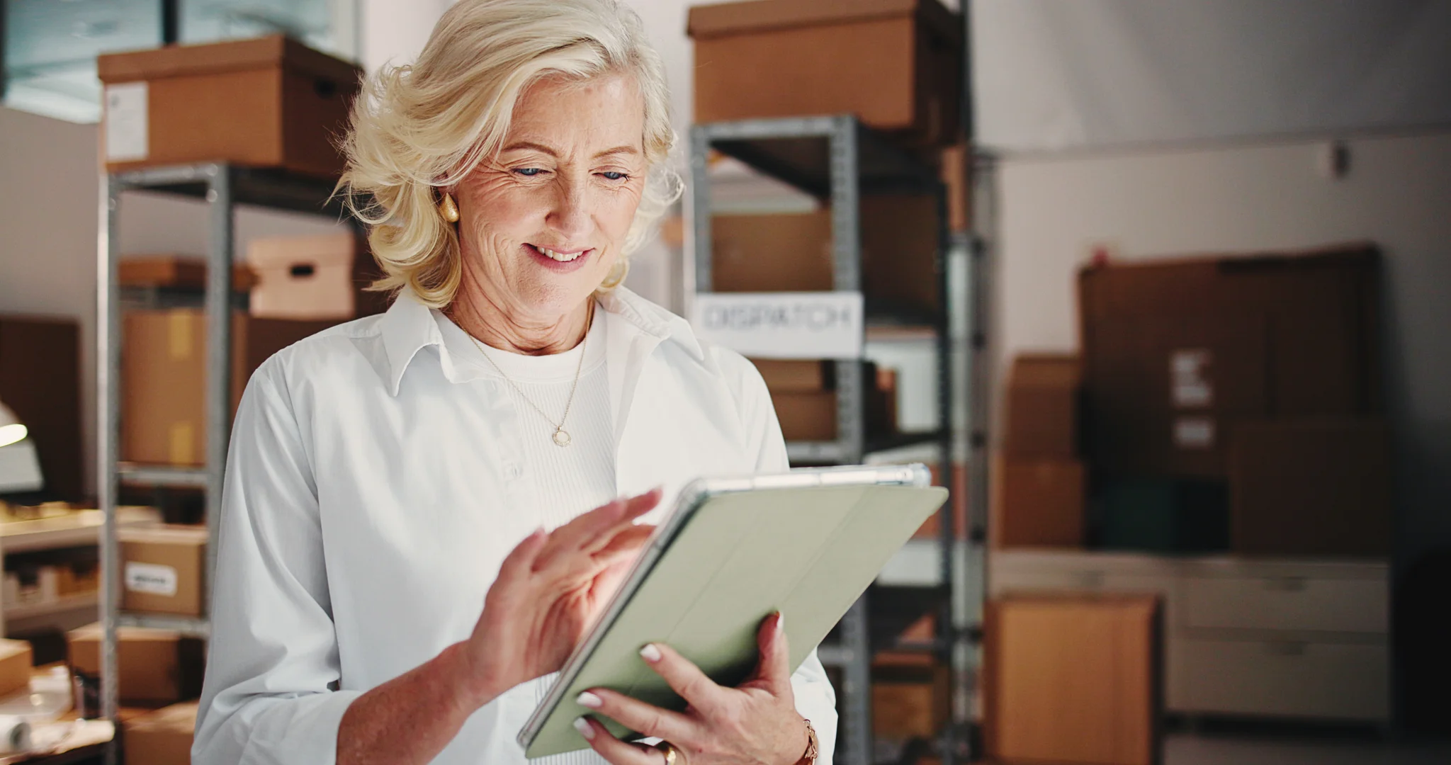 Ecommerce, woman or reading on tablet in warehouse, check product sales or digital inventory management. Supplier website, startup or mature entrepreneur with dropshipping order, tech or stock admin