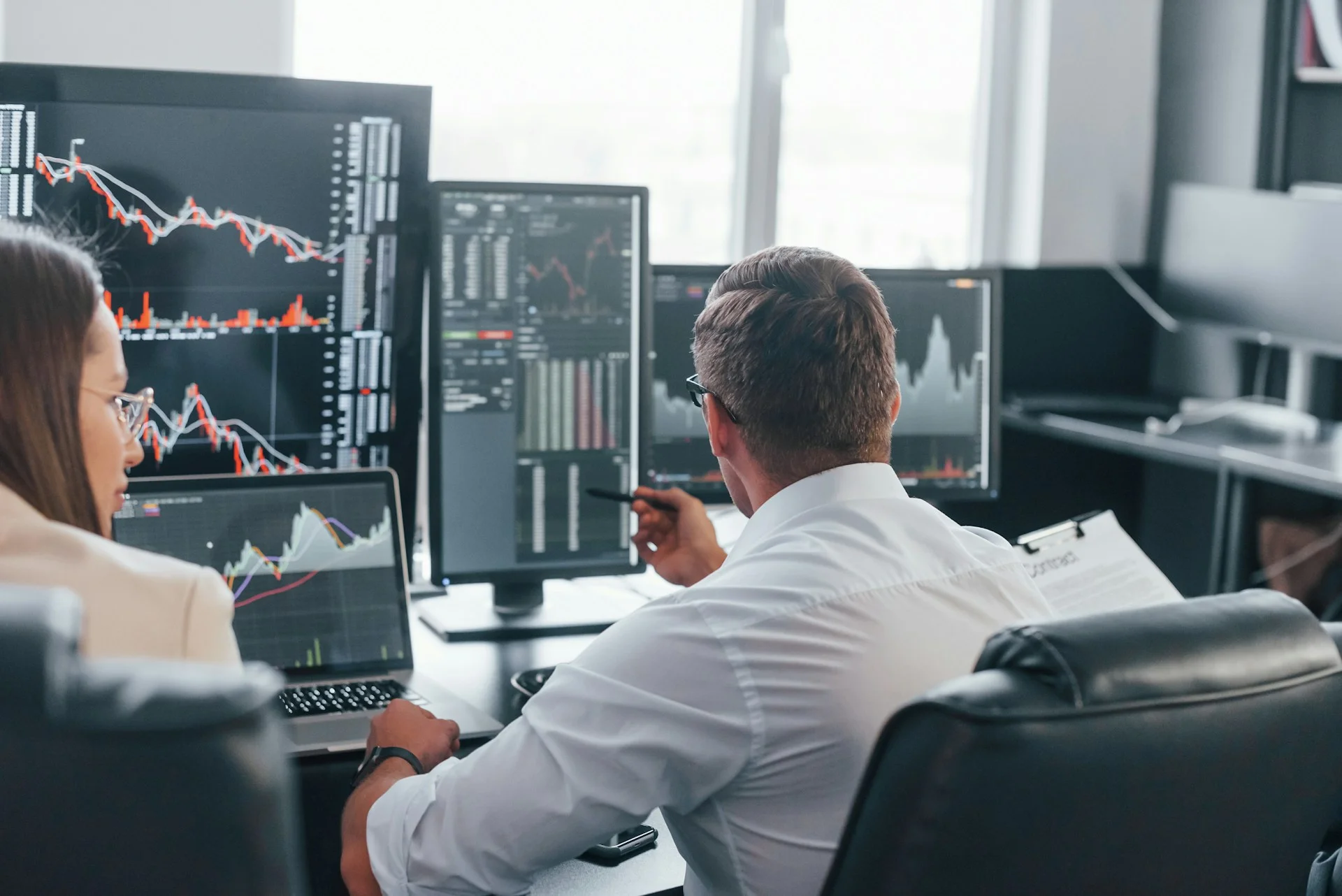 man and woman working with computers