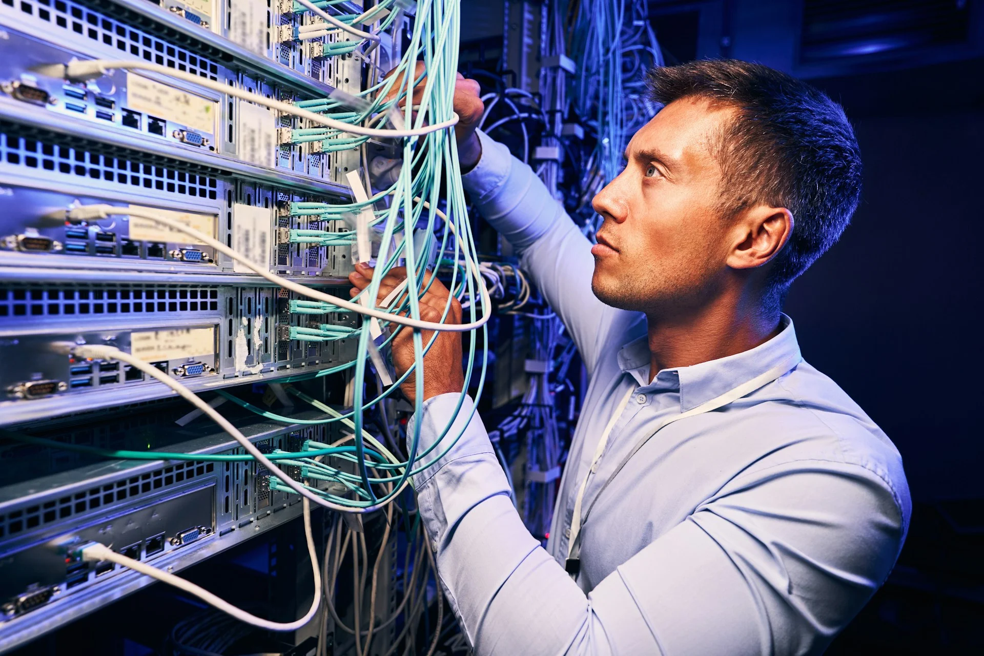 man working with computer wires