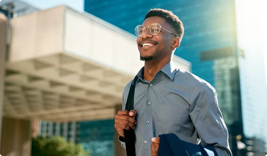 man walking in sunny city